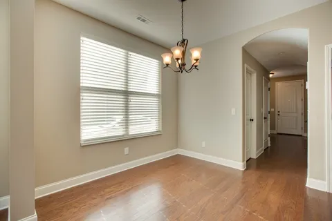 a view of a chandelier and a chandelier fan in a room