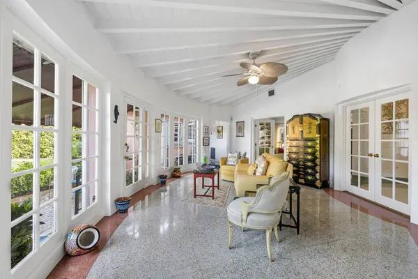 a living room with furniture and large windows