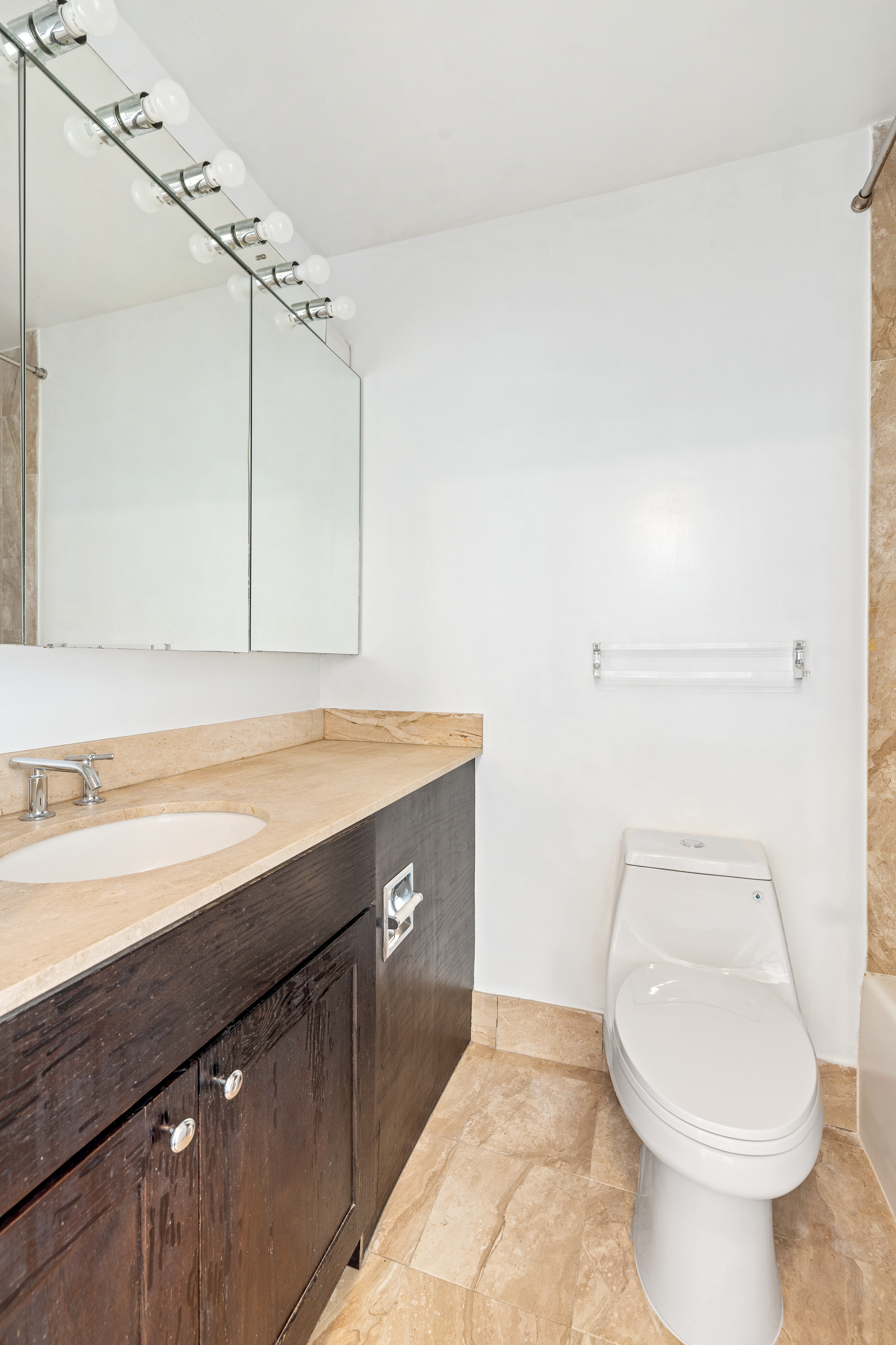 145 East 48th Street, Unit 8D Manhattan, NY 10017 - Photo 6 of 9 a bathroom with a sink a toilet and shower