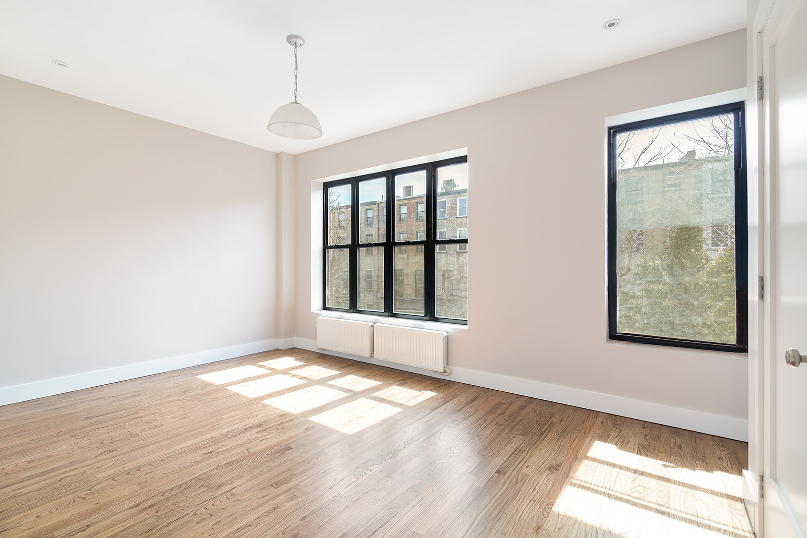 356 Halsey Street, Unit 2 Brooklyn, NY 11216 - Photo 6 of 9 a view of an empty room with glass door and wooden floor