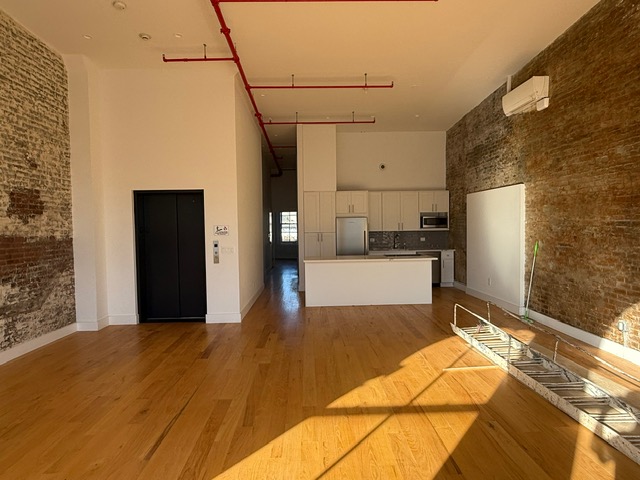 103 Broadway, Unit PH Brooklyn, NY 11249 - Photo 3 of 8 a bedroom with a bed and a cabinets