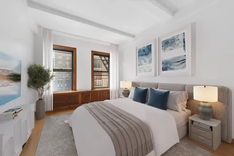 a bedroom with a large bed and a window