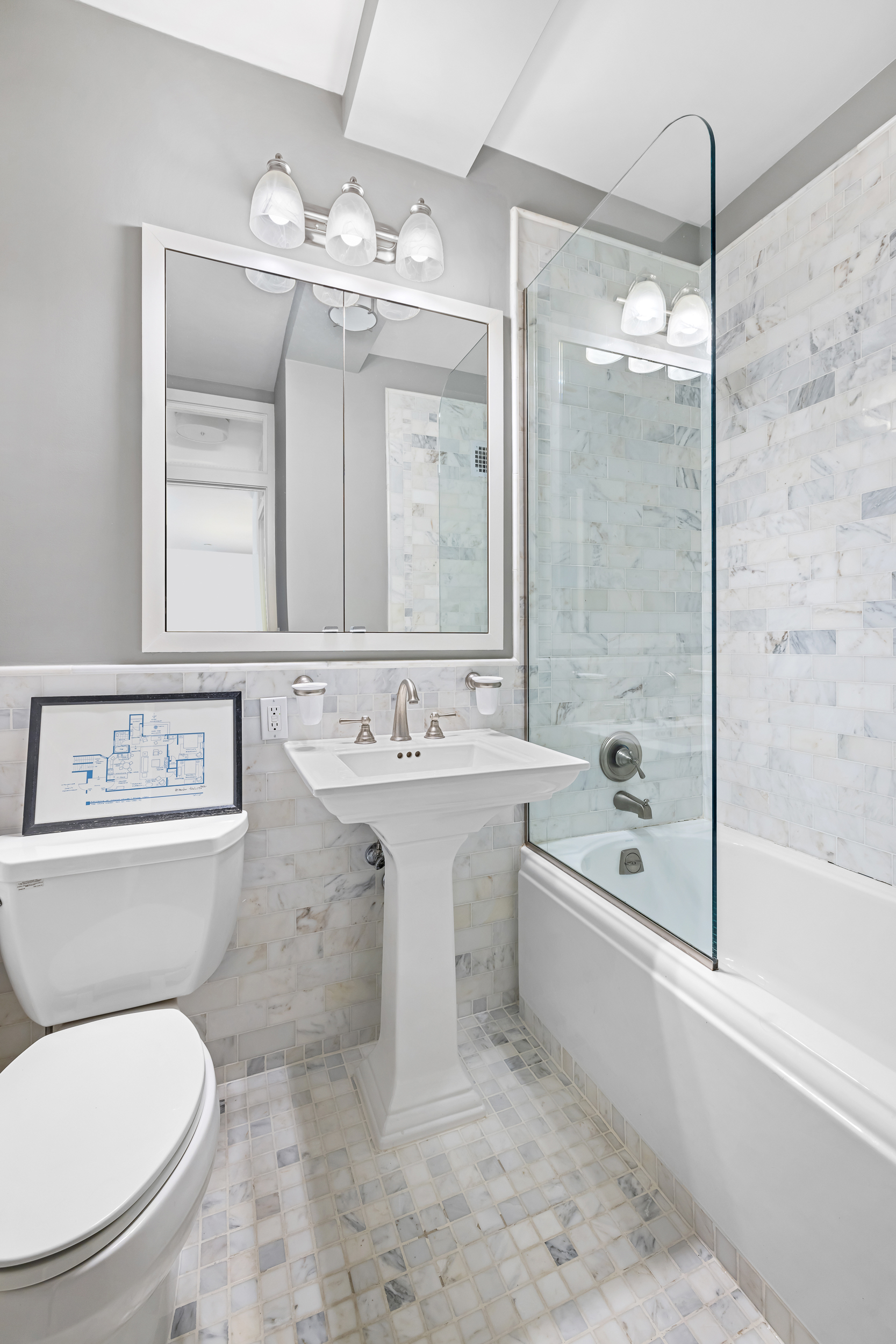 23 East 10th Street, Unit 231 Manhattan, NY 10003 - Photo 5 of 9 a bathroom with a sink toilet a mirror and bathtub