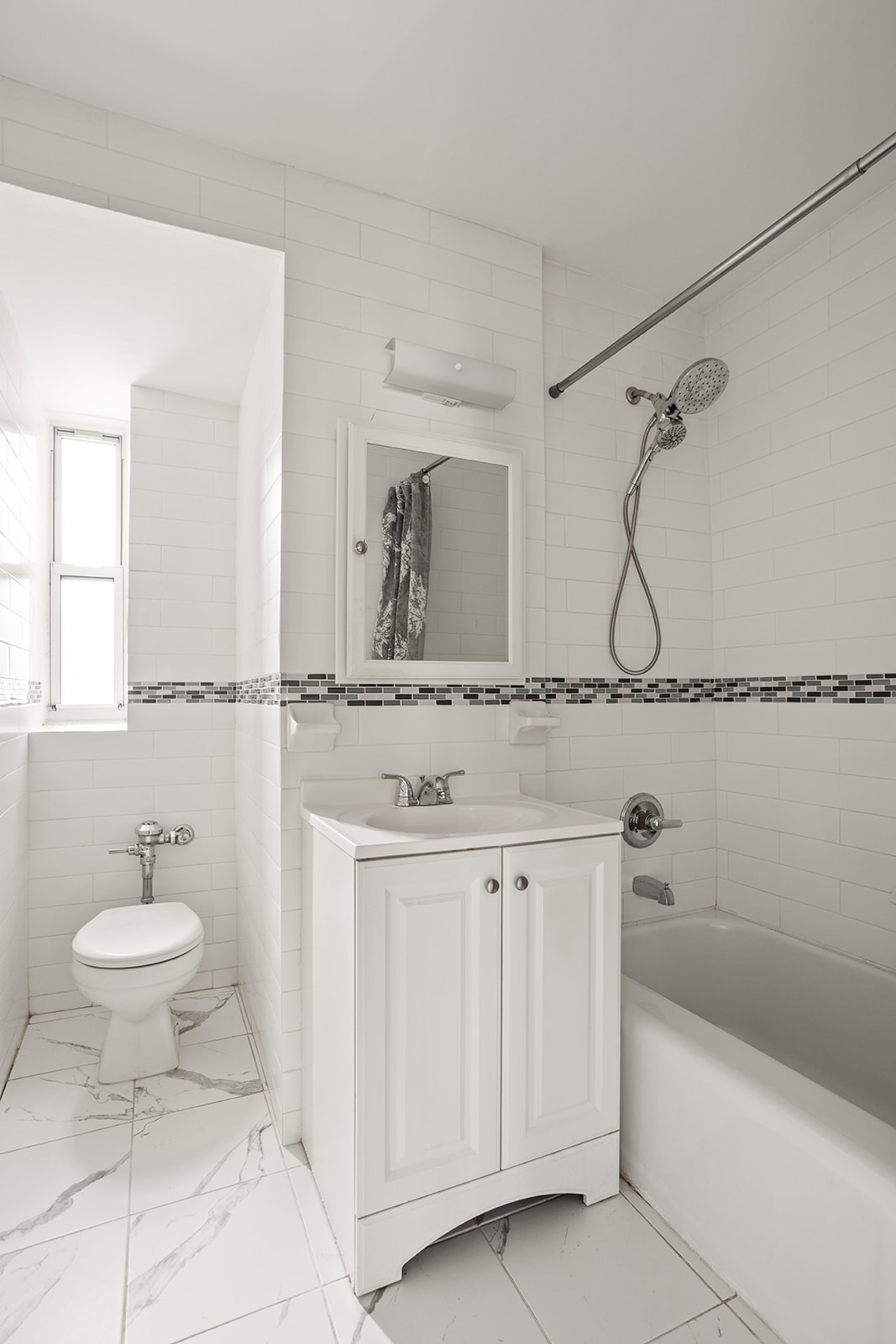 33-16 82nd Street, Unit 4C Queens, NY 11372 - Photo 7 of 13 a bathroom with a sink and a mirror