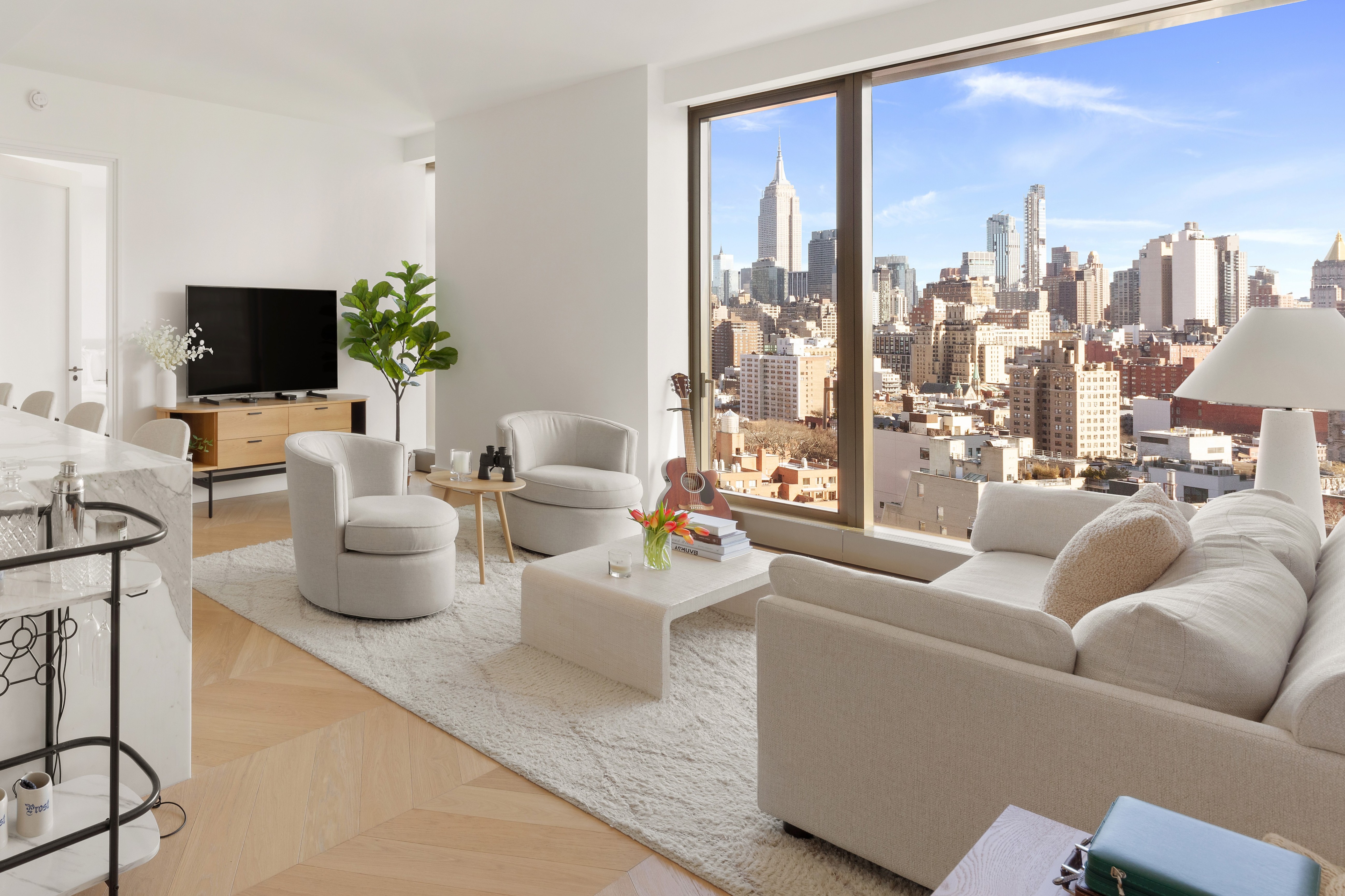 a living room with furniture a lamp and a flat screen tv