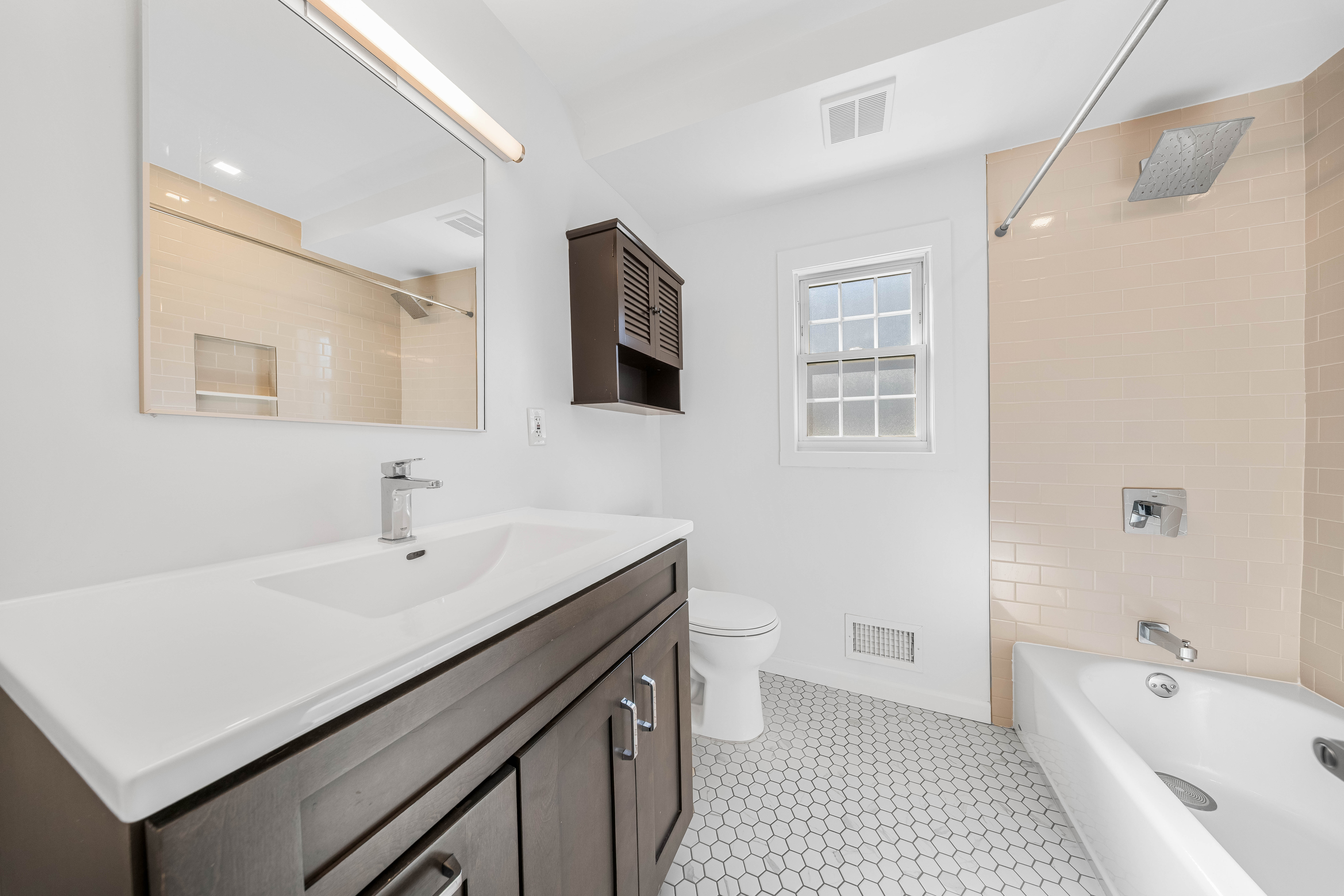 15-80 209th Street, Unit 2 Queens, NY 11360 - Photo 9 of 21 a bathroom with a sink a toilet a shower and a mirror