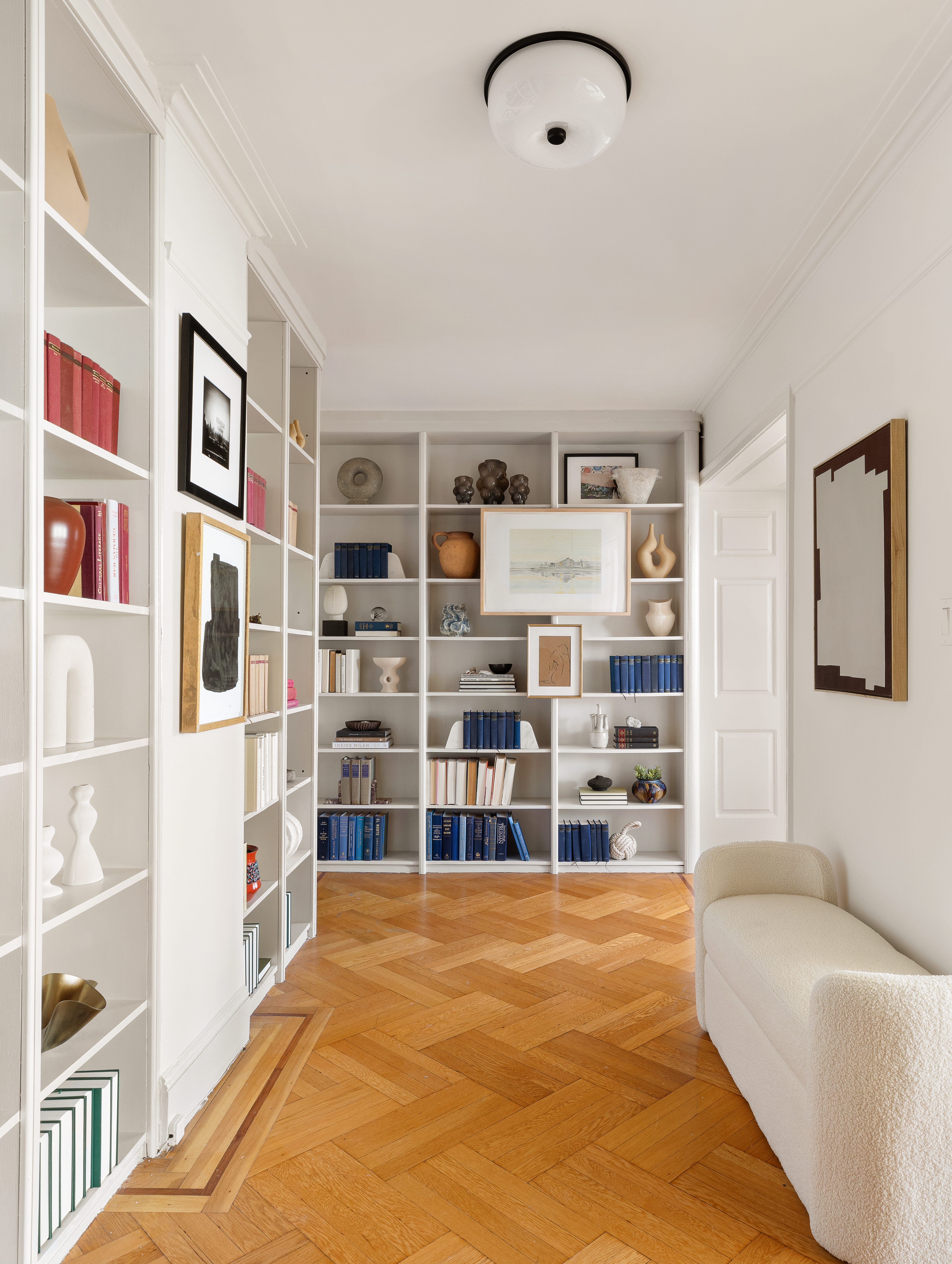 35 Prospect Park West, Unit 10B Brooklyn, NY 11215 - Photo 16 of 19 a living room with lots of furniture and a book shelf