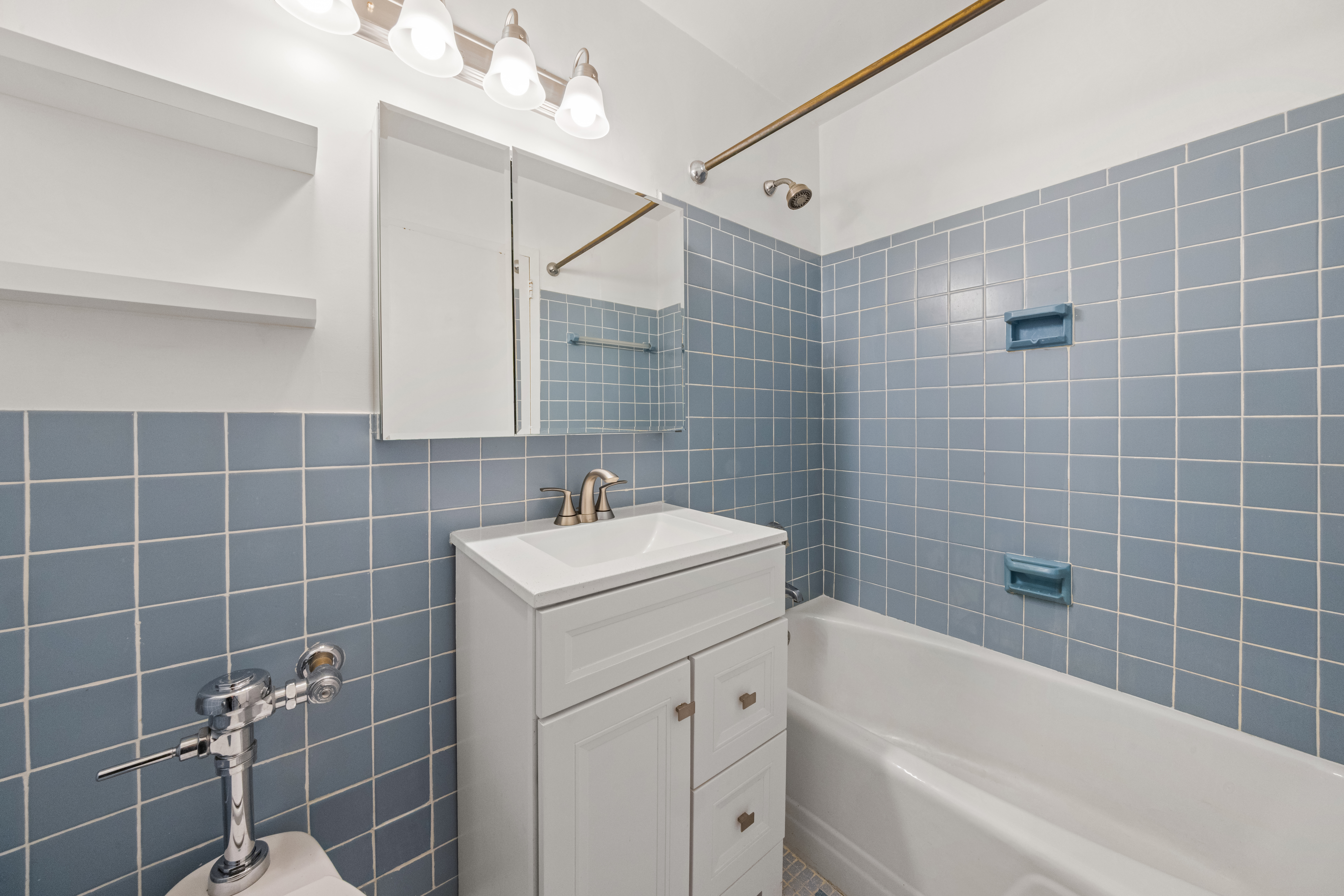 1160 3rd Avenue, Unit 7C Manhattan, NY 10065 - Photo 6 of 7 a bathroom with a sink mirror toilet shower and bathtub