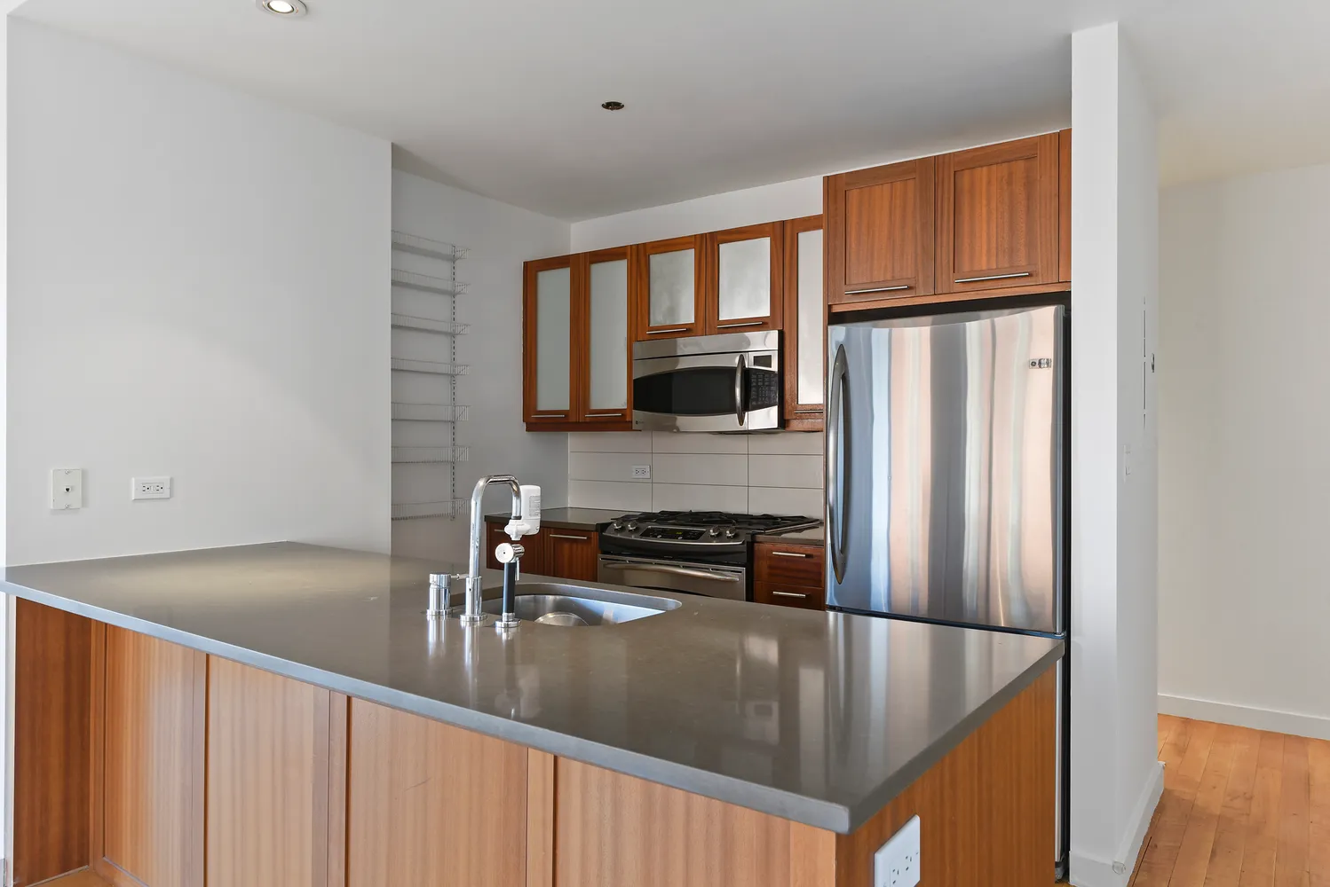 a kitchen with stainless steel appliances granite countertop a sink a stove and a refrigerator