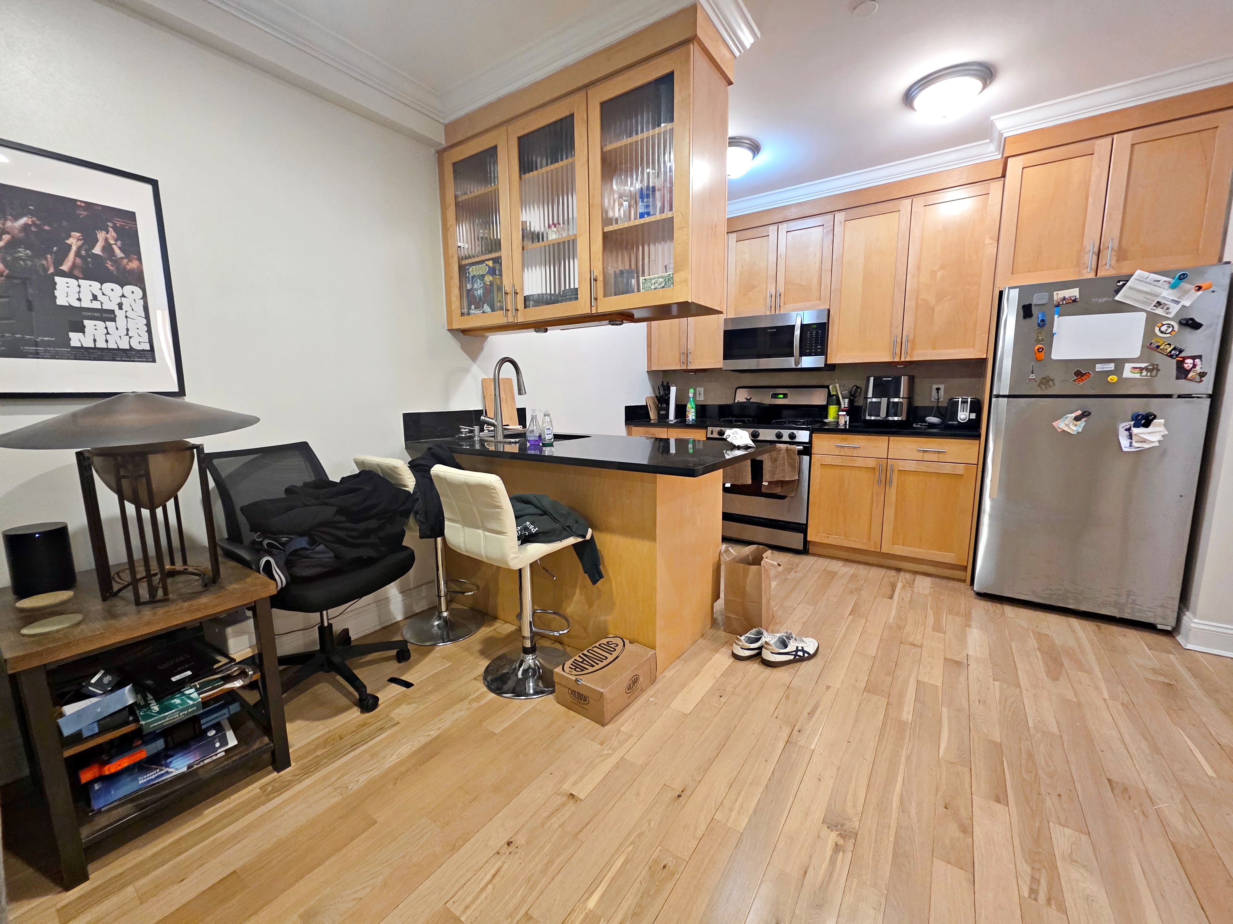 190 Meserole Avenue, Unit 2N Brooklyn, NY 11222 - Photo 5 of 10 a kitchen with stainless steel appliances granite countertop a stove top oven a sink dishwasher and cabinets with wooden floor