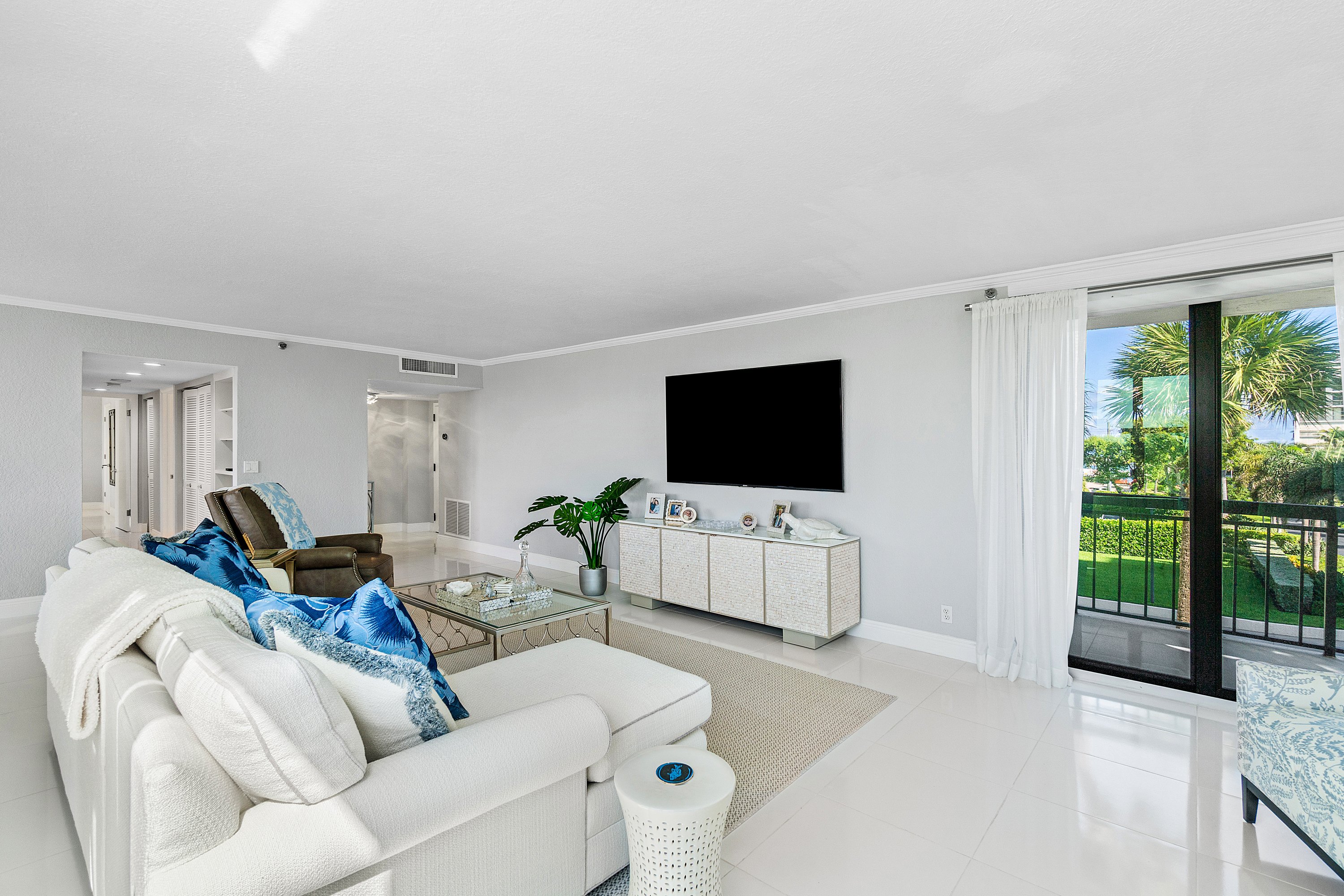 2003 North Ocean Boulevard, Unit 305 Boca Raton, FL 33431 - Photo 14 of 56 a living room with furniture and a flat screen tv