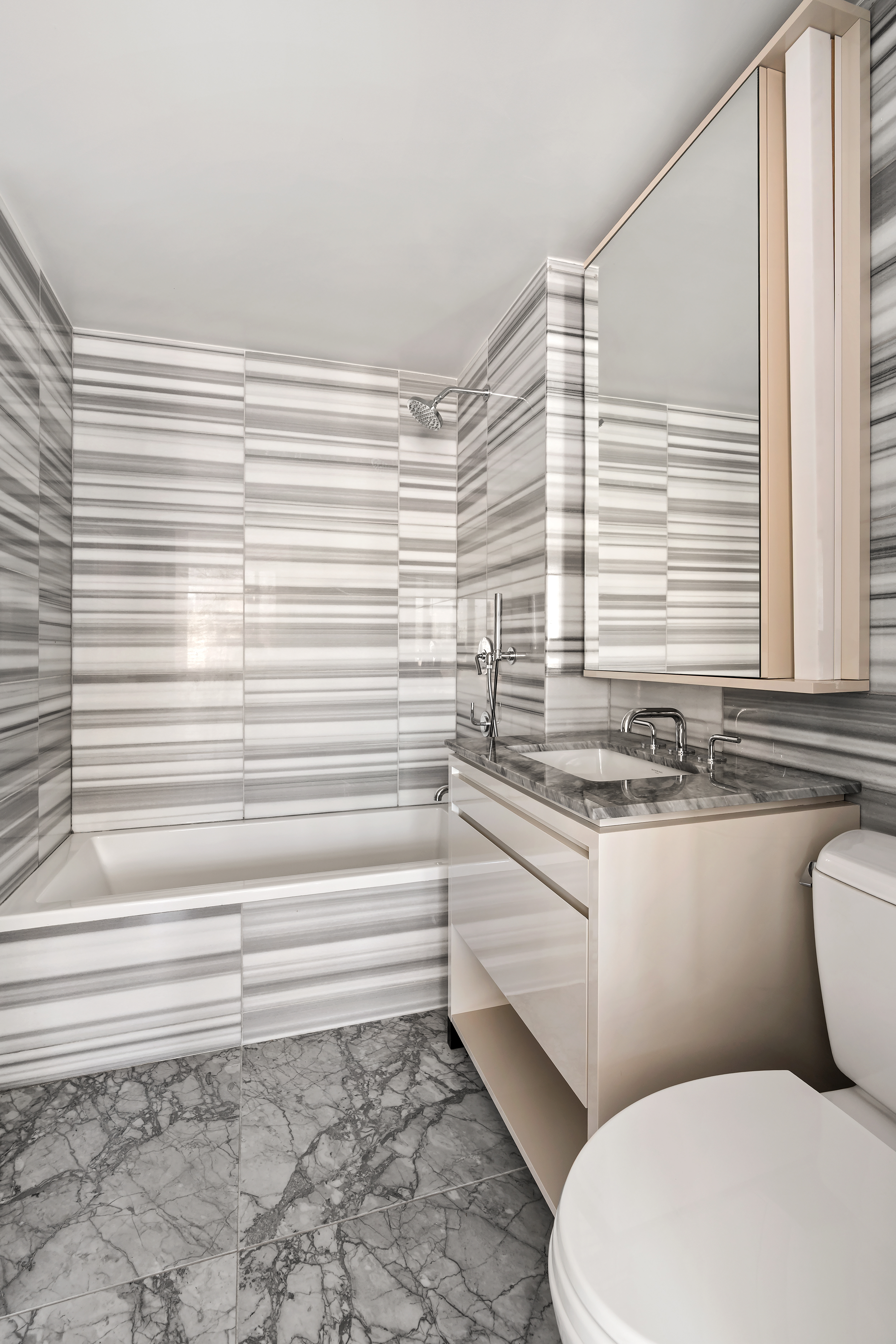 385 1st Avenue, Unit 20B Manhattan, NY 10010 - Photo 5 of 10 a bathroom with a toilet a sink and a window