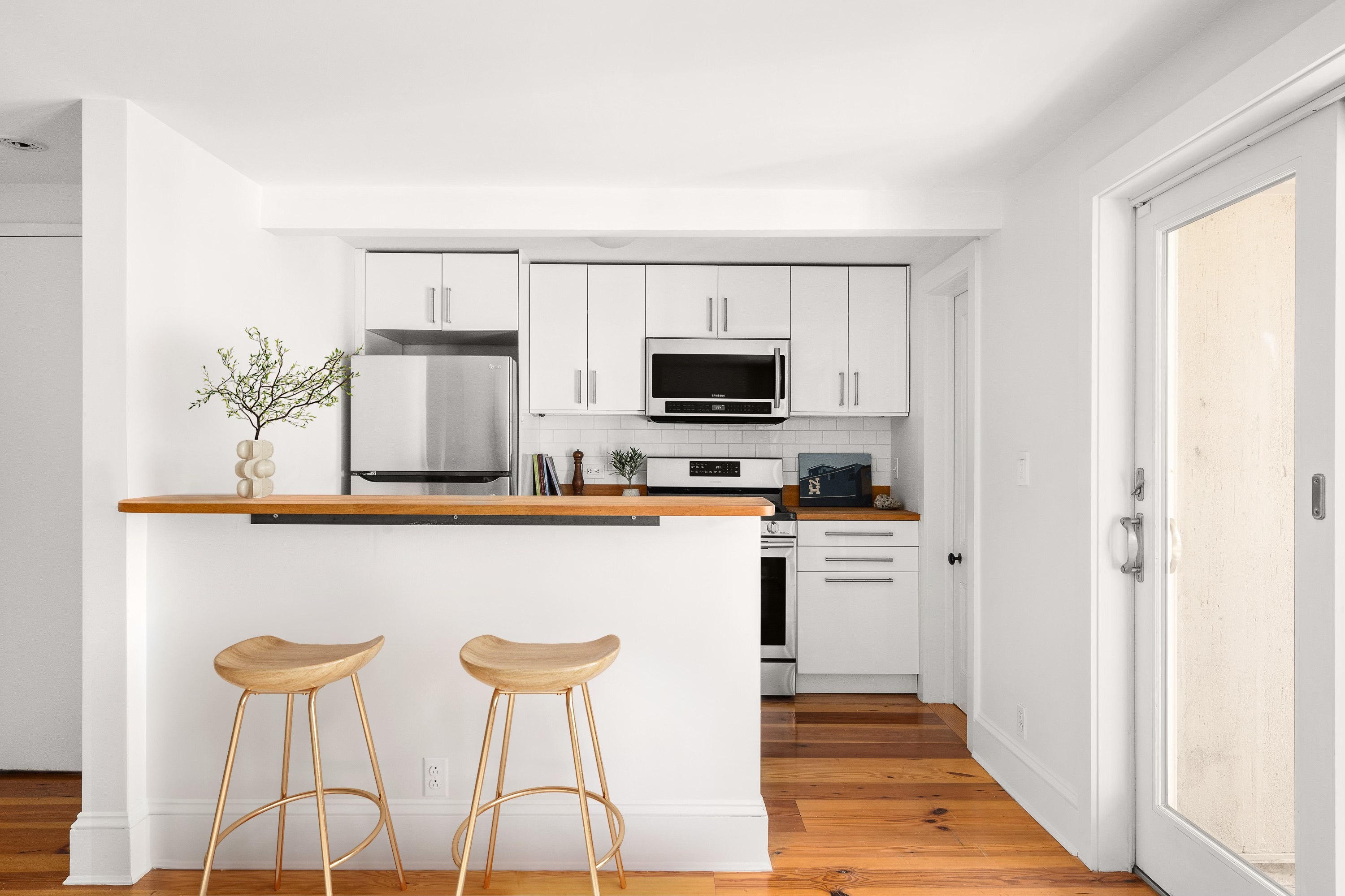 250 Cumberland Street, Unit GARDEN Brooklyn, NY 11205 - Photo 2 of 5 a kitchen with stainless steel appliances a stove a refrigerator cabinets and a dining table