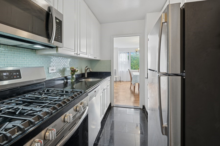 4525 Henry Hudson Parkway West, Unit 506 Bronx, NY 10471 - Photo 5 of 12 a kitchen with stainless steel appliances granite countertop a stove and a refrigerator