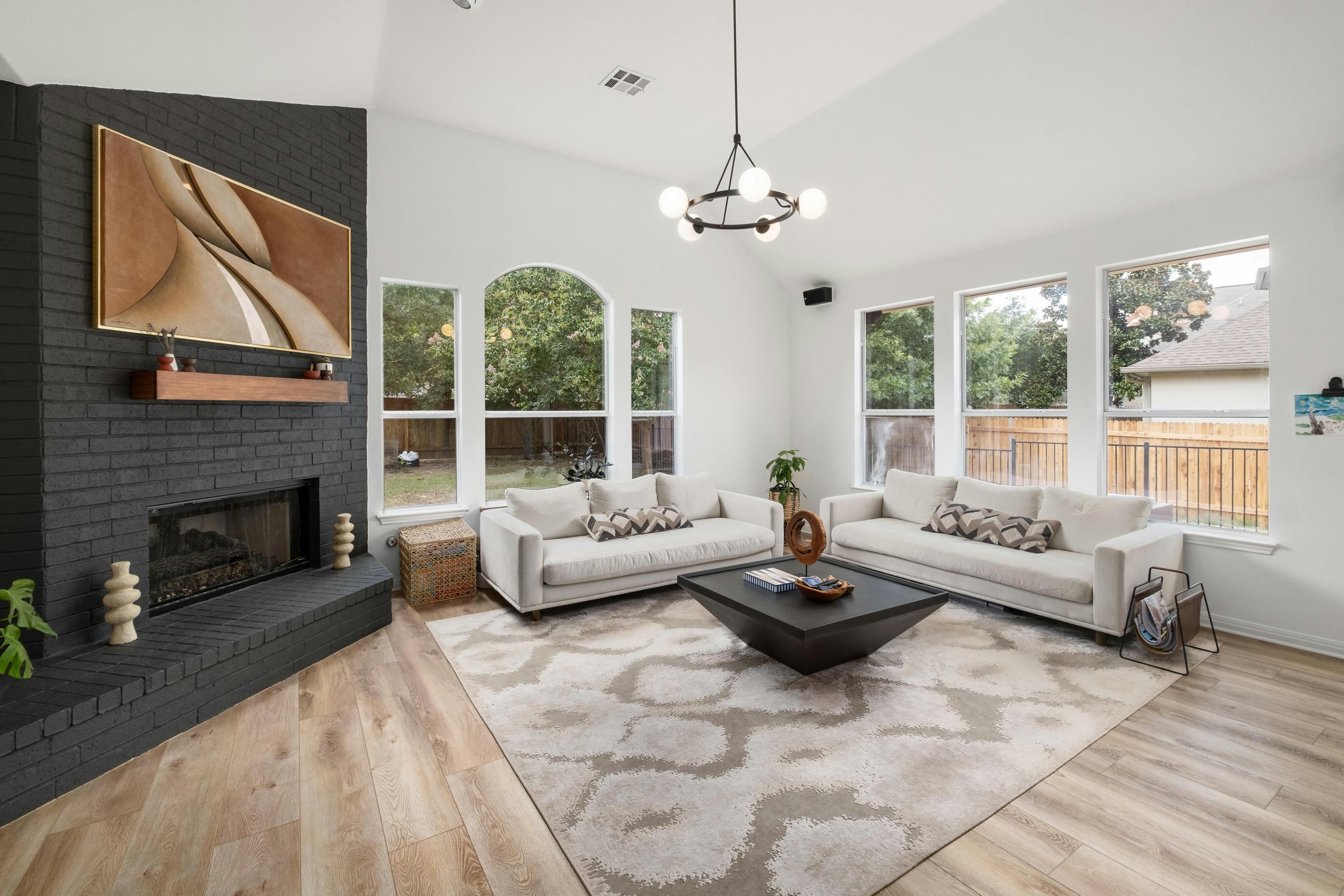 10608 Pointe View Drive Austin, TX 78738 - Photo 11 of 46 a living room with furniture a fireplace and a large window