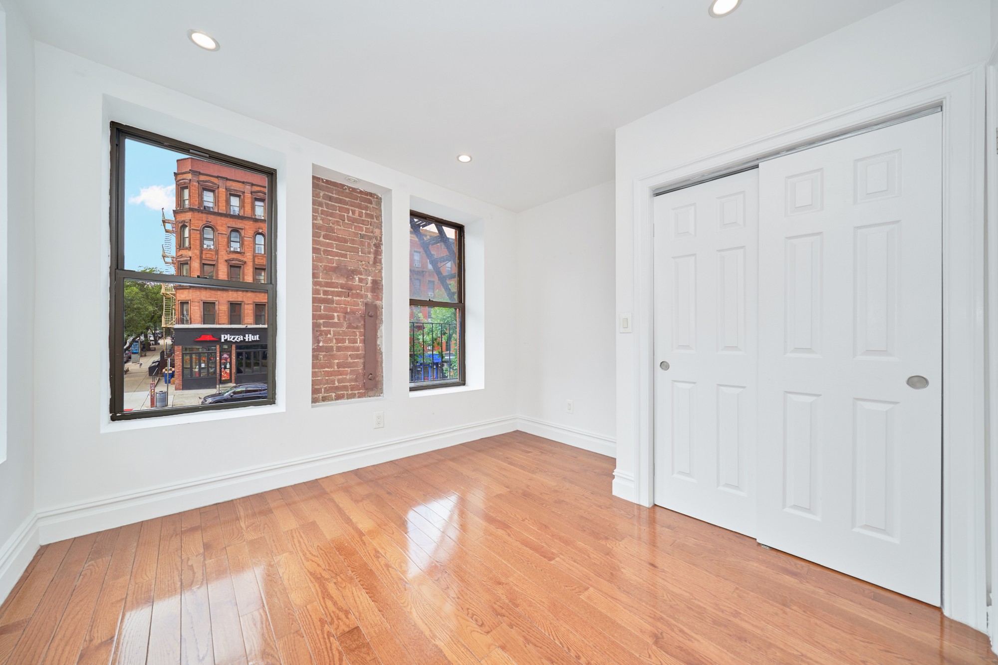 941 Columbus Avenue, Unit 1A Manhattan, NY 10025 - Photo 4 of 14 a view of an empty room with a window and wooden floor