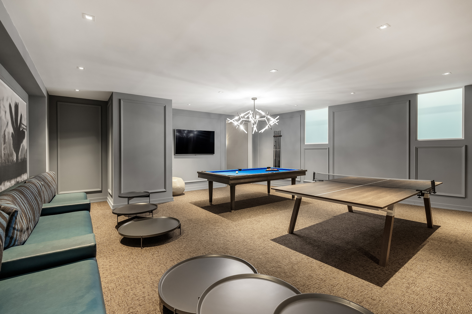 344 West 72nd Street, Unit 1007 Manhattan, NY 10023 - Photo 19 of 23 a living room with furniture a rug and a flat screen tv