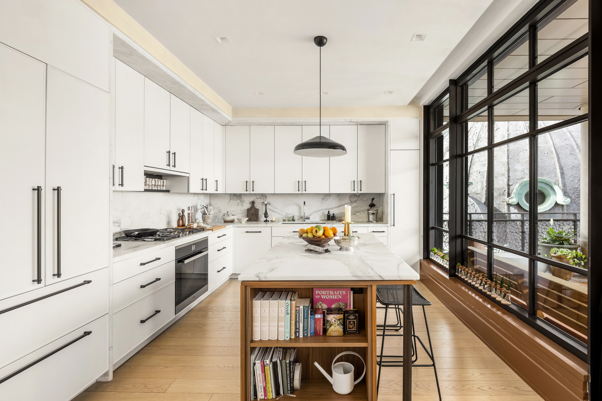 25 Park Row, Unit 29A Manhattan, NY 10038 - Photo 6 of 23 a kitchen with stainless steel appliances granite countertop a stove a refrigerator a sink dishwasher and white cabinets next to a window