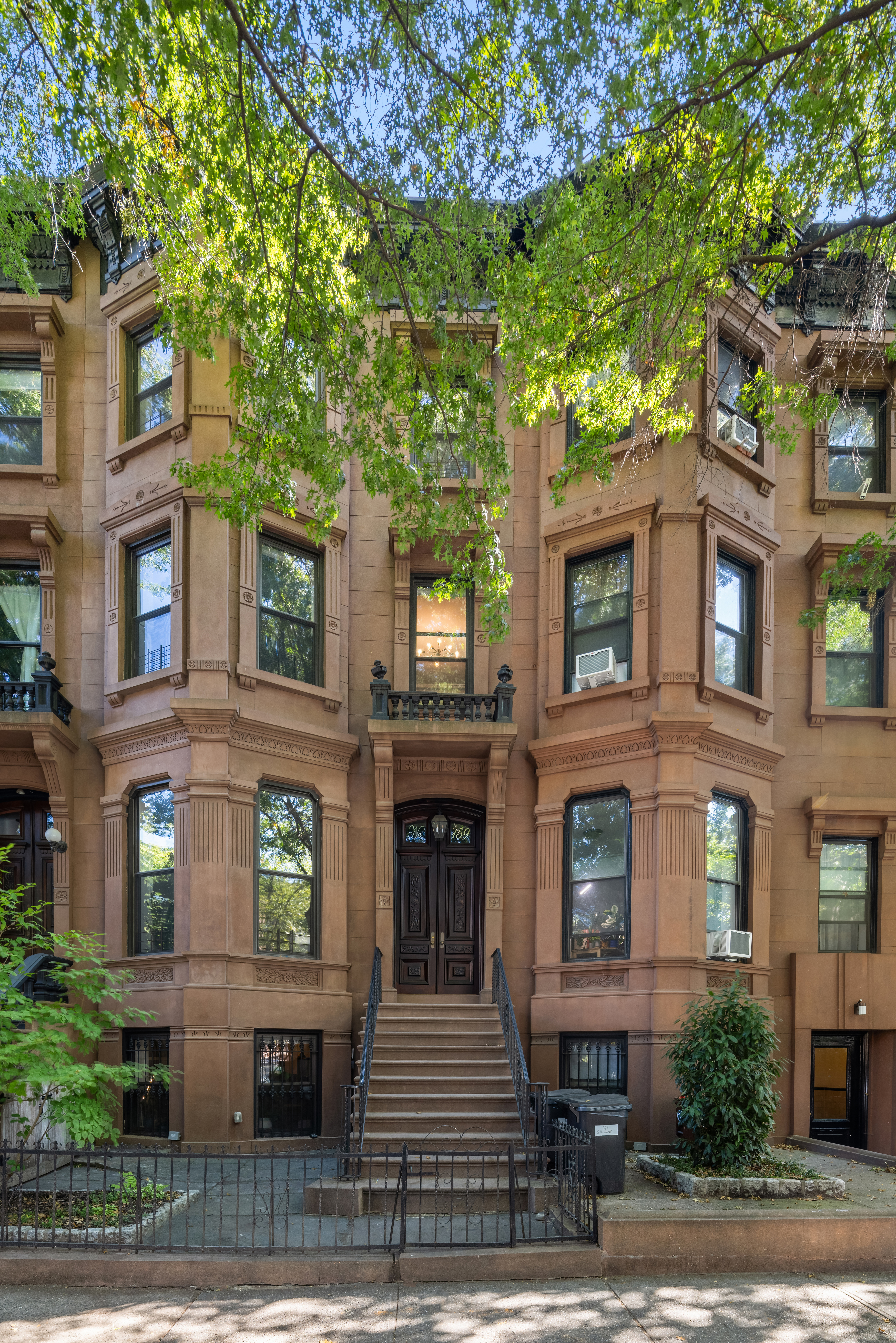159 6th Avenue, Unit TRIPLEX Brooklyn, NY 11217 - Photo 18 of 19 a front view of a residential apartment building with a yard