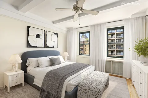 a bedroom with a large bed and a window