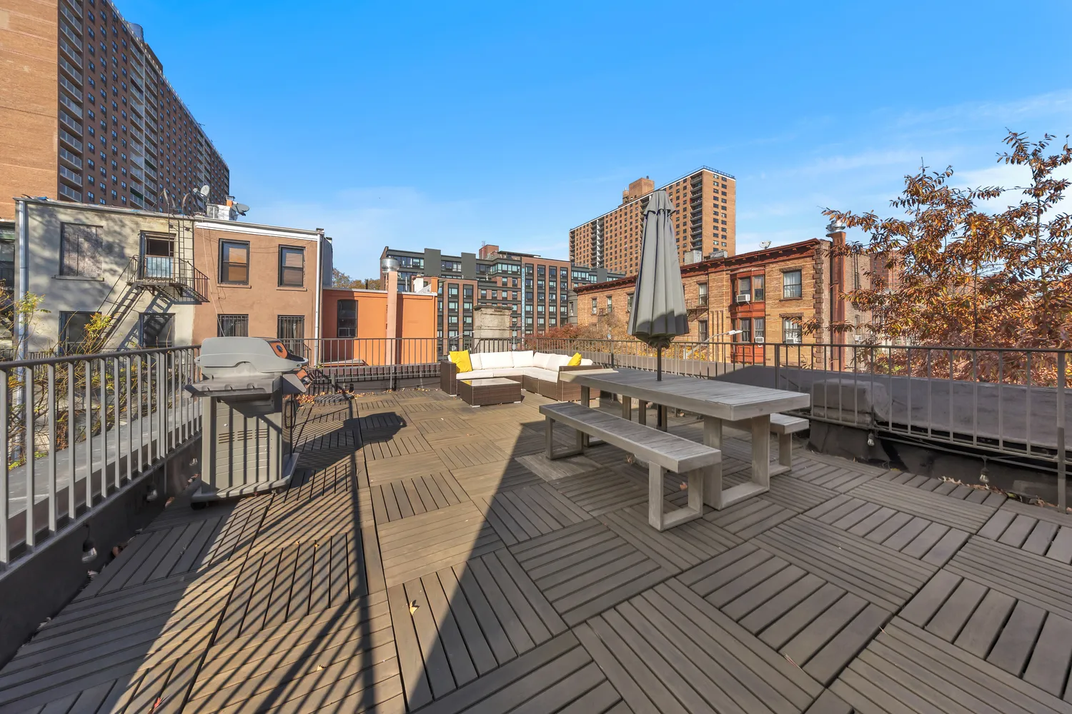 a view of a balcony with wooden floor and outdoor seating