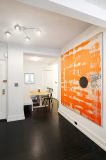 a dining room with furniture and wooden floor