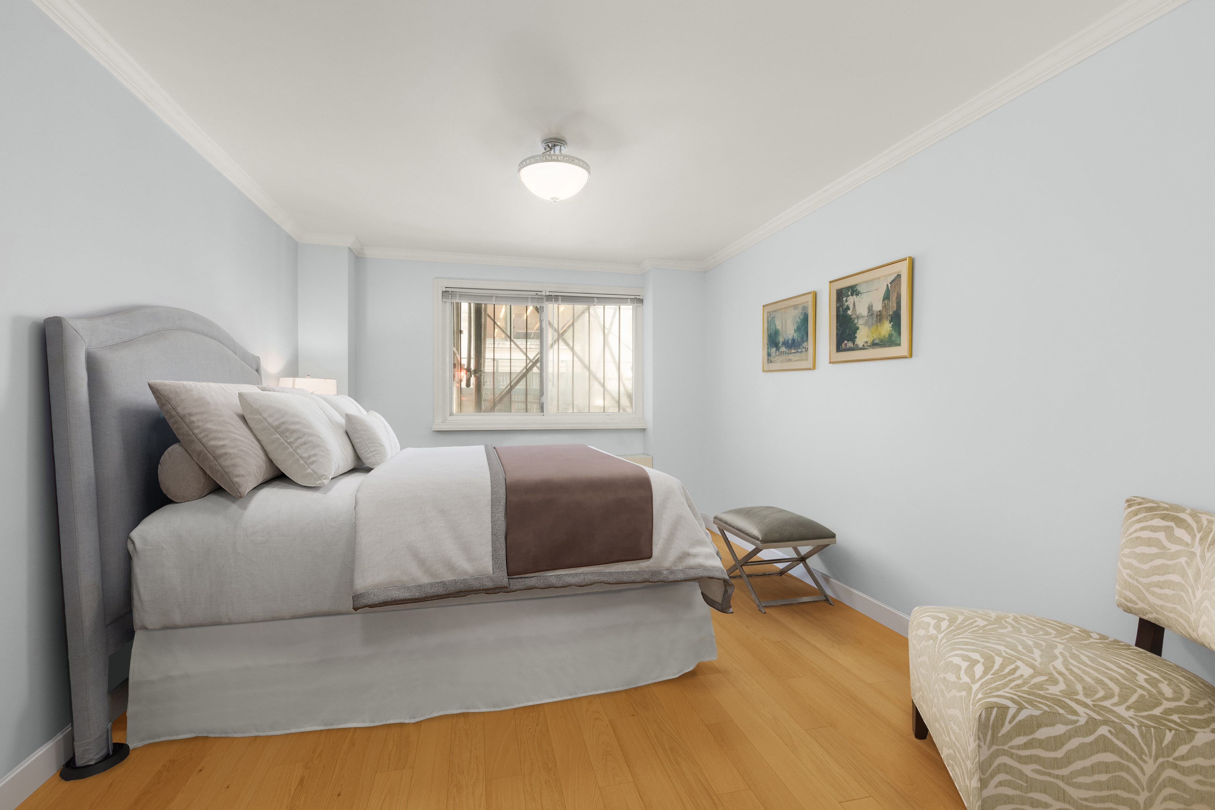 7 East 35th Street, Unit 2E Manhattan, NY 10016 - Photo 6 of 10 a bedroom with a bed and a couch