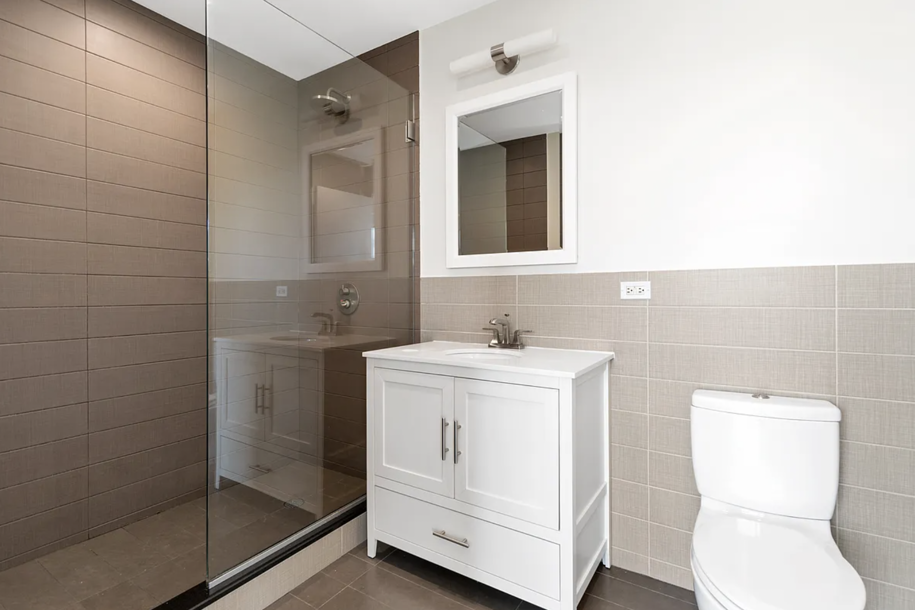 5-43 48th Avenue, Unit 5E Queens, NY 11101 - Photo 5 of 9 a bathroom with a sink toilet and shower