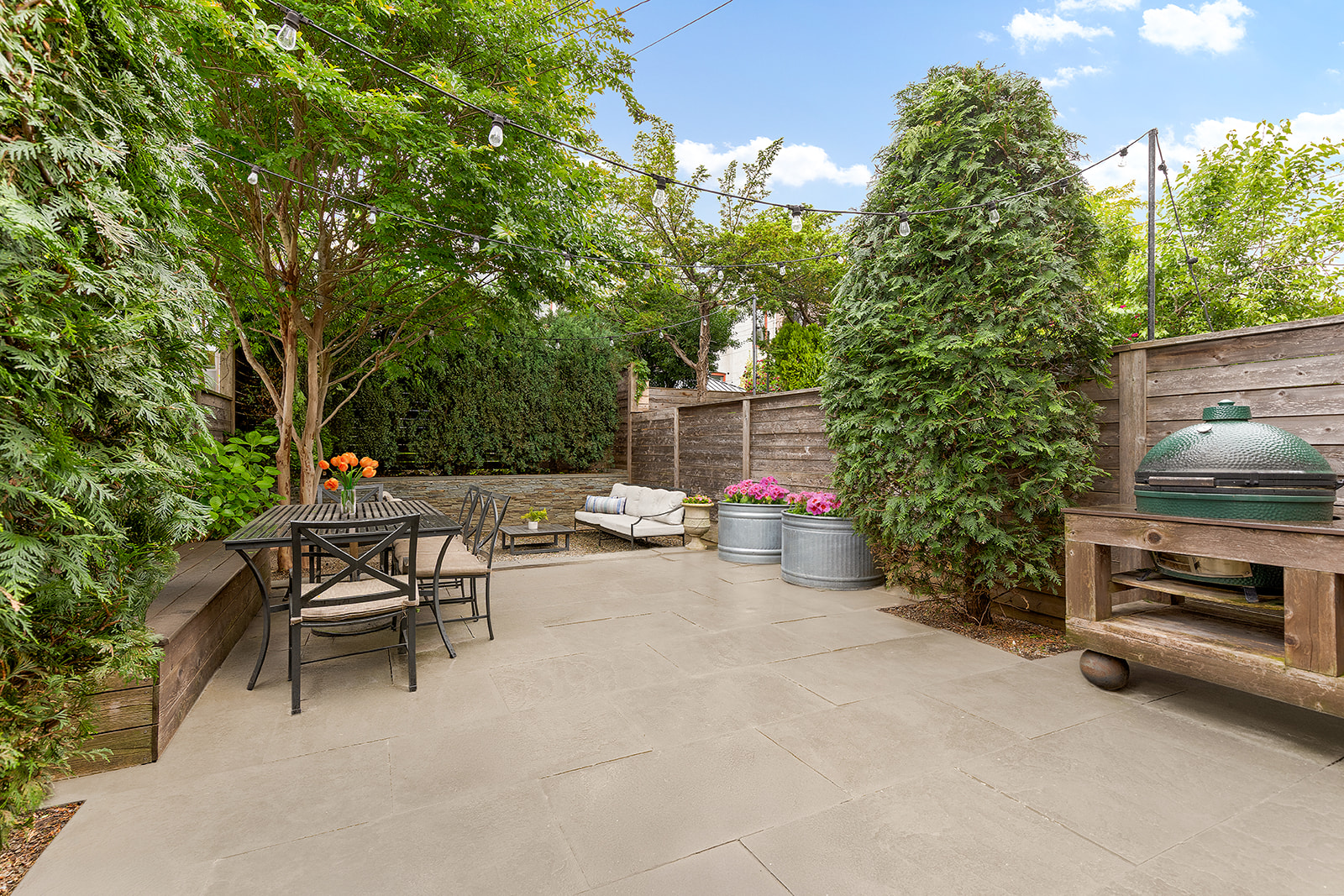 203 Lefferts Avenue Brooklyn, NY 11225 - Photo 2 of 12 a view of a patio with a table and chairs and potted plants