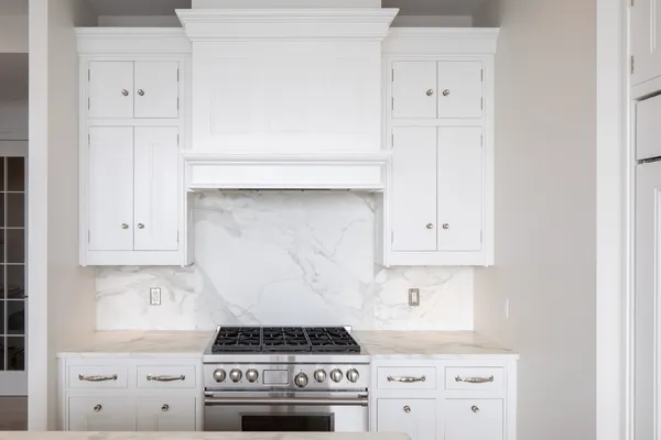 a stove top oven sitting inside of a kitchen