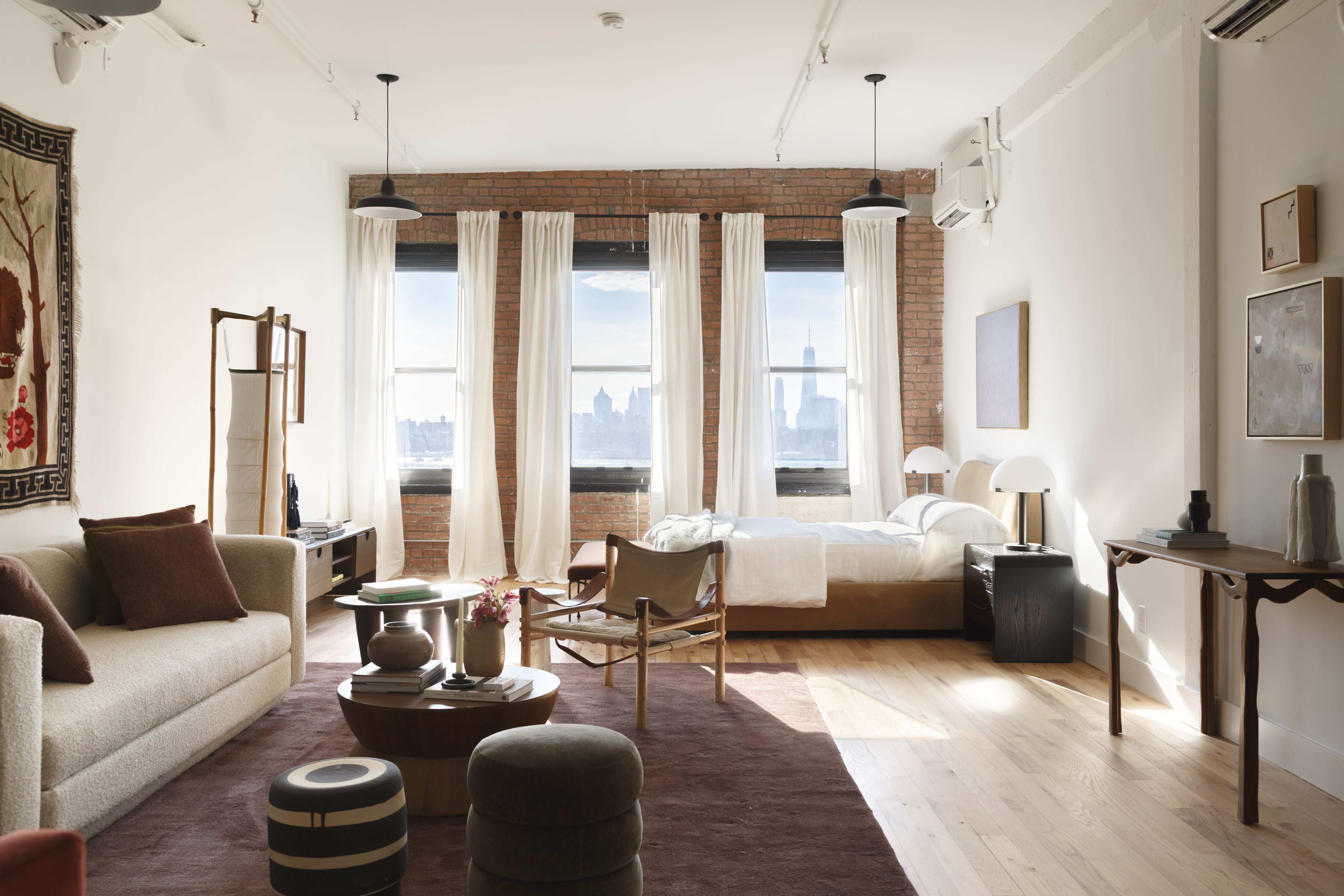 a living room with furniture and floor to ceiling windows