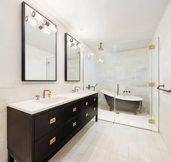 a bathroom with a double vanity sink mirror and bathtub