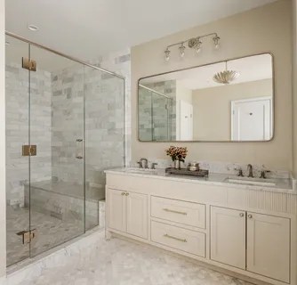 a bathroom with a double vanity sink mirror and shower