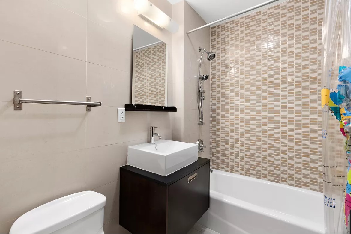 502 9th Avenue, Unit 5A Manhattan, NY 10018 - Photo 4 of 5 a bathroom with a sink toilet and vanity