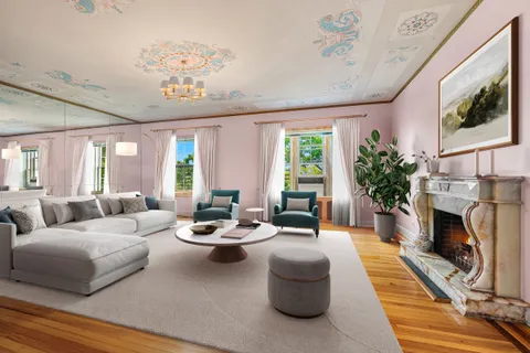 a living room with furniture fireplace and a large window