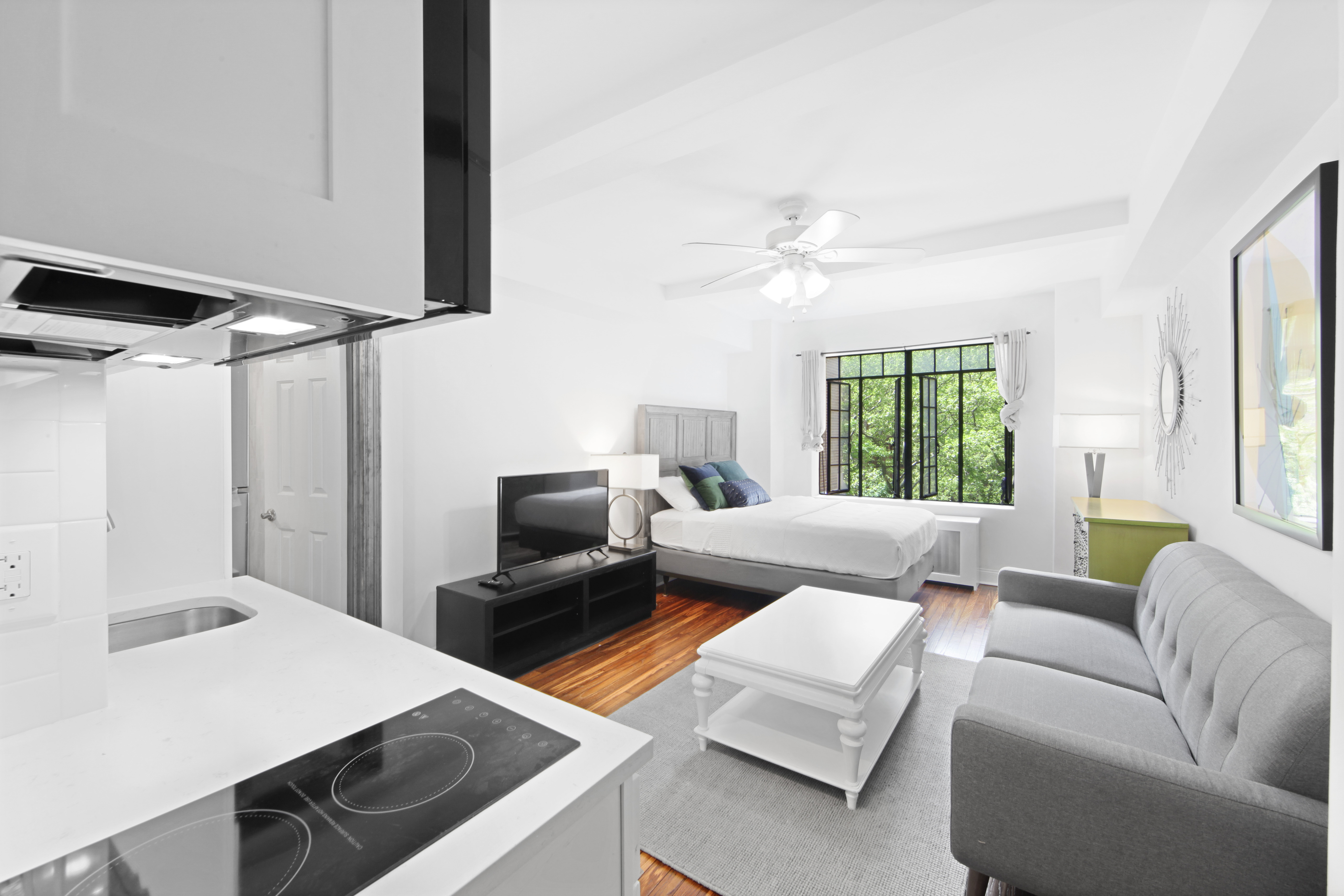 25 Tudor City Place, Unit 508 Manhattan, NY 10017 - Photo 5 of 17 a living room with furniture and a large window
