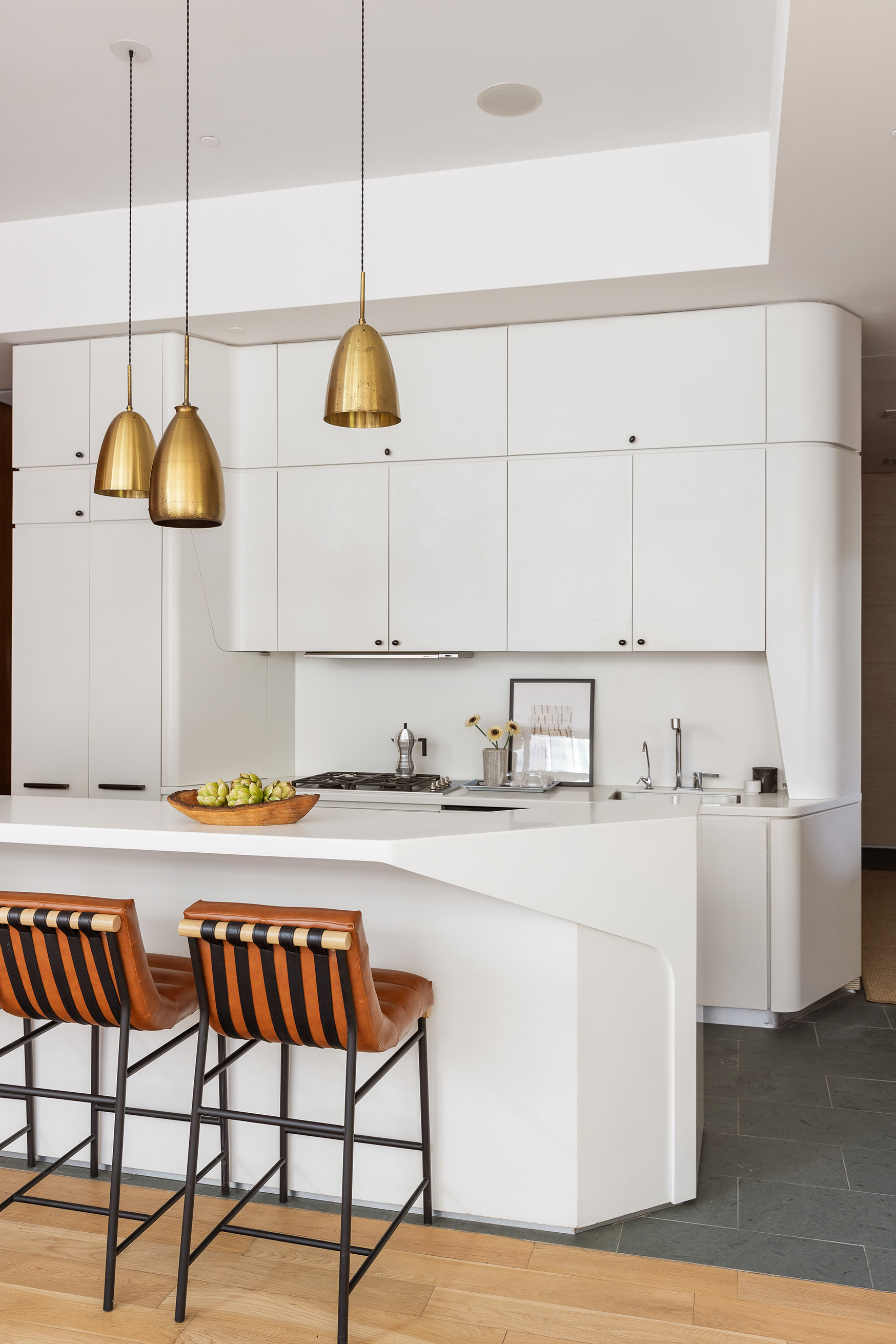 166 Perry Street, Unit 1C Manhattan, NY 10014 - Photo 4 of 18 a kitchen with stainless steel appliances granite countertop a sink a stove and a wooden floors