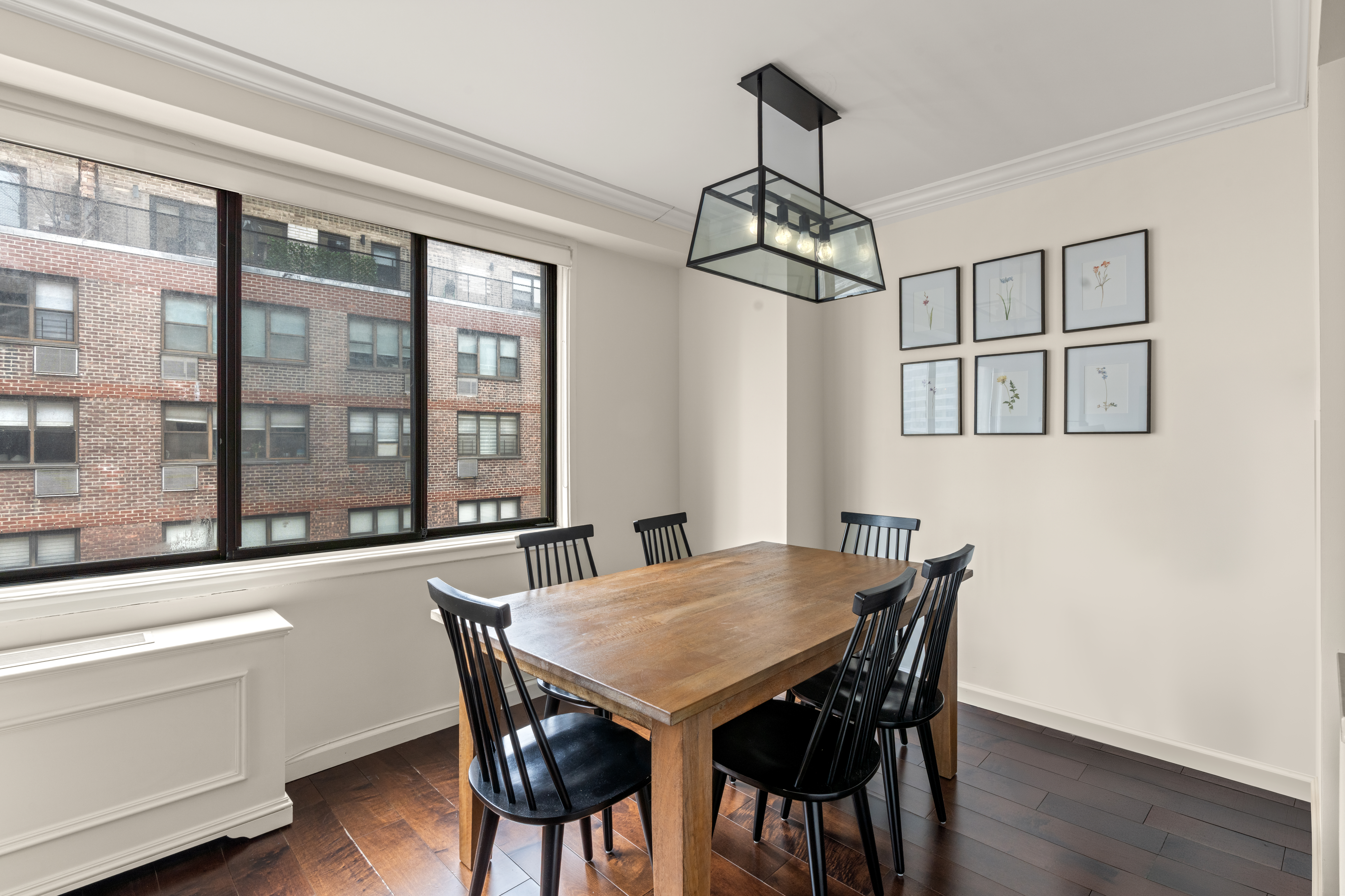 345 East 73rd Street, Unit 11KL Manhattan, NY 10021 - Photo 3 of 12 a view of a dining room with furniture window and wooden floor