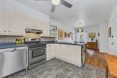 a kitchen with stainless steel appliances granite countertop a stove and a refrigerator