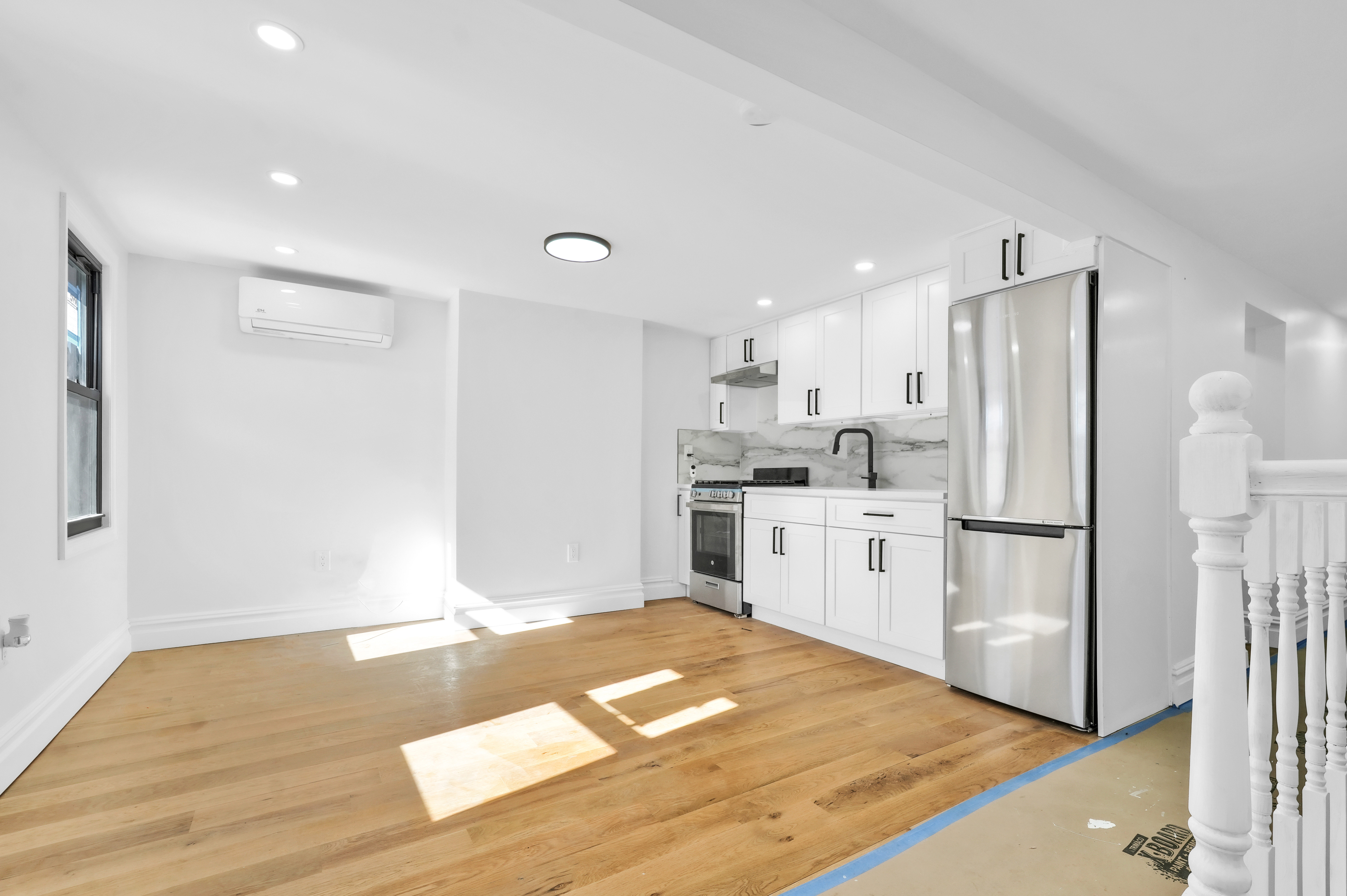 473 Monroe Street Brooklyn, NY 11221 - Photo 30 of 40 a kitchen with white cabinets and stainless steel appliances