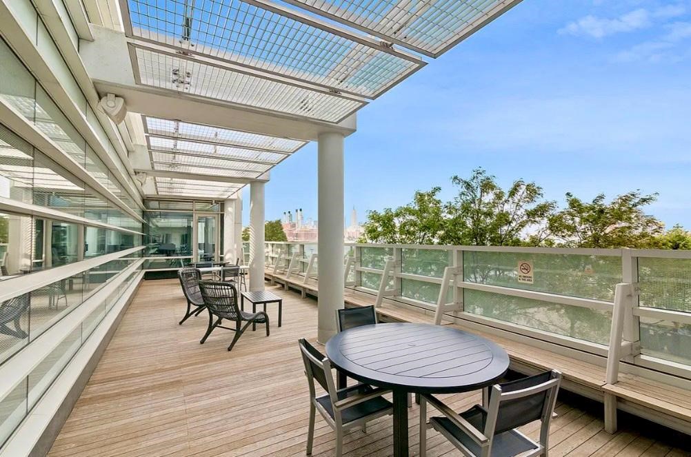 2 Northside Piers, Unit 26C Brooklyn, NY 11249 - Photo 17 of 21 a outdoor space with lots of furniture and a lake view