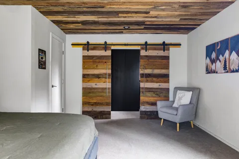 a bedroom with a bed and a chair