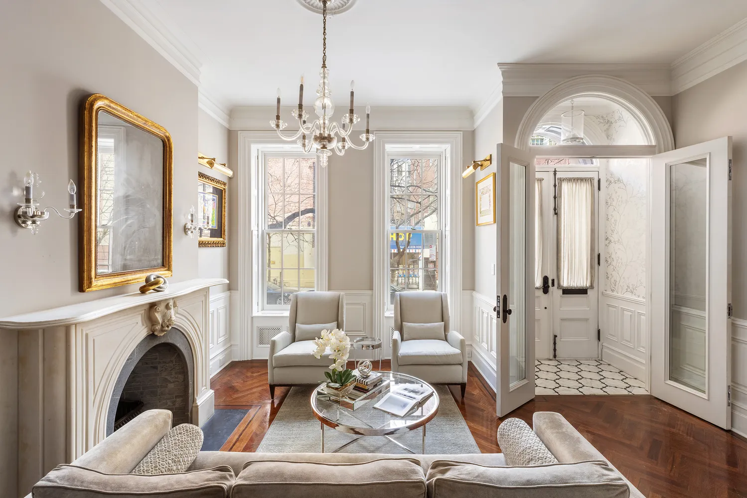 a living room with furniture a fireplace and a chandelier