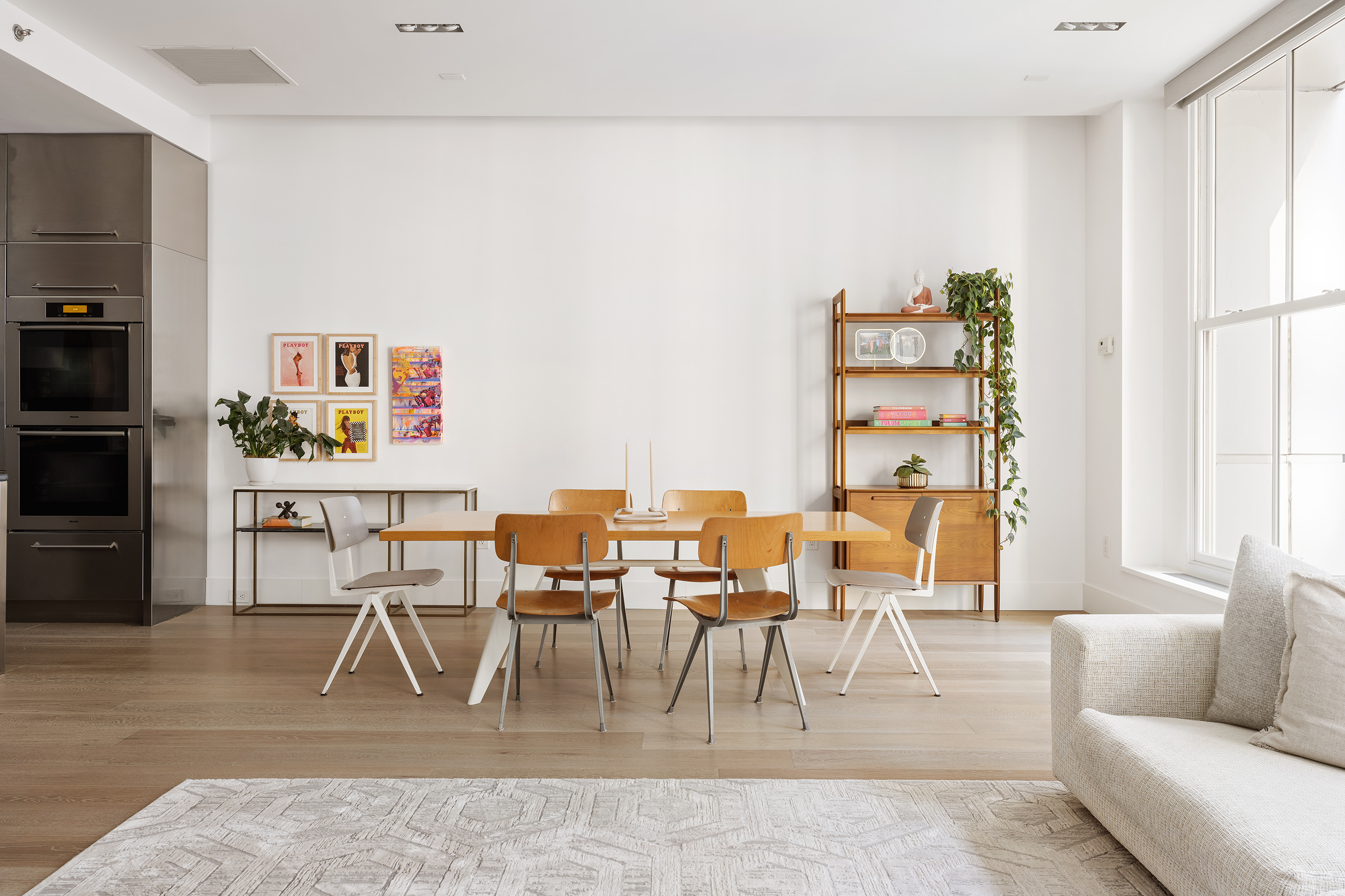 51 Walker Street, Unit 4B Manhattan, NY 10013 - Photo 2 of 13 a living room with furniture a rug and a dining table
