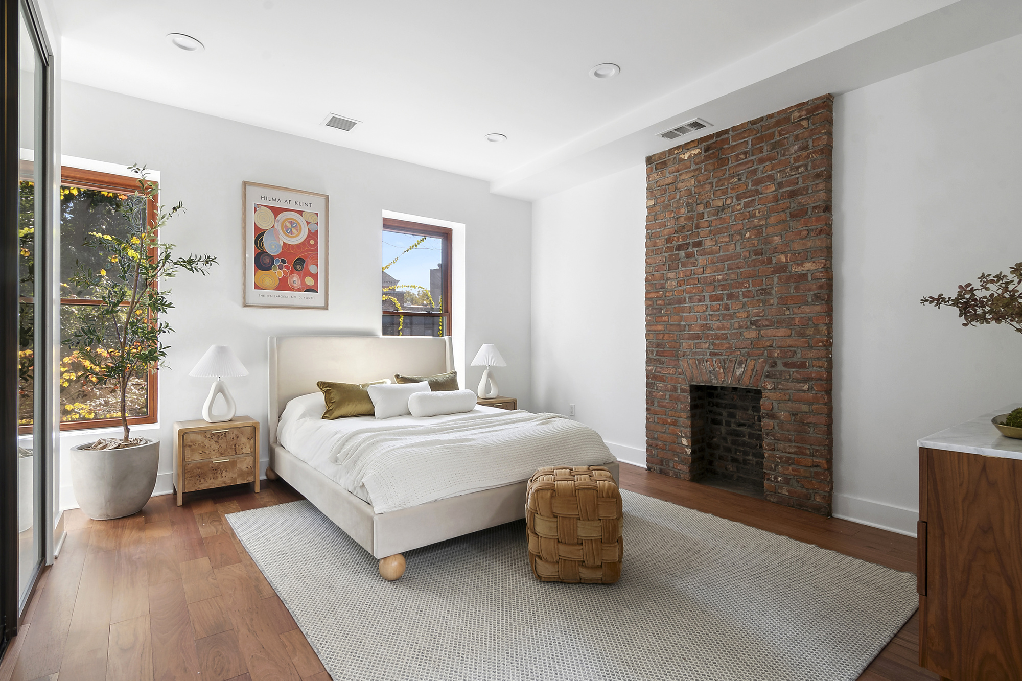 698 Halsey Street Brooklyn, NY 11233 - Photo 5 of 13 a spacious bedroom with a bed and a fireplace