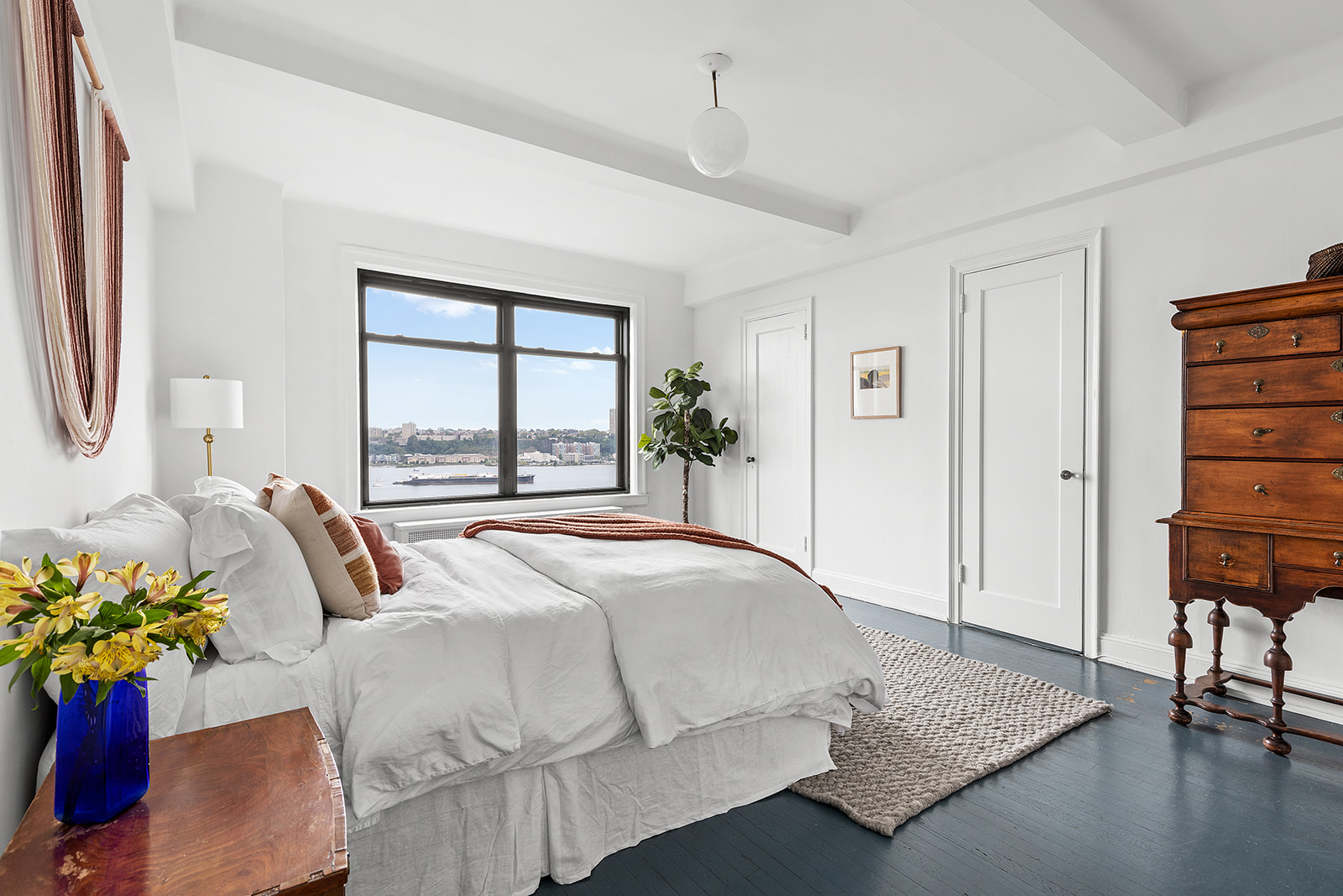 110-118 Riverside Drive, Unit 15A Manhattan, NY 10024 - Photo 8 of 17 a bedroom with a bed potted plant with the view of bathroom
