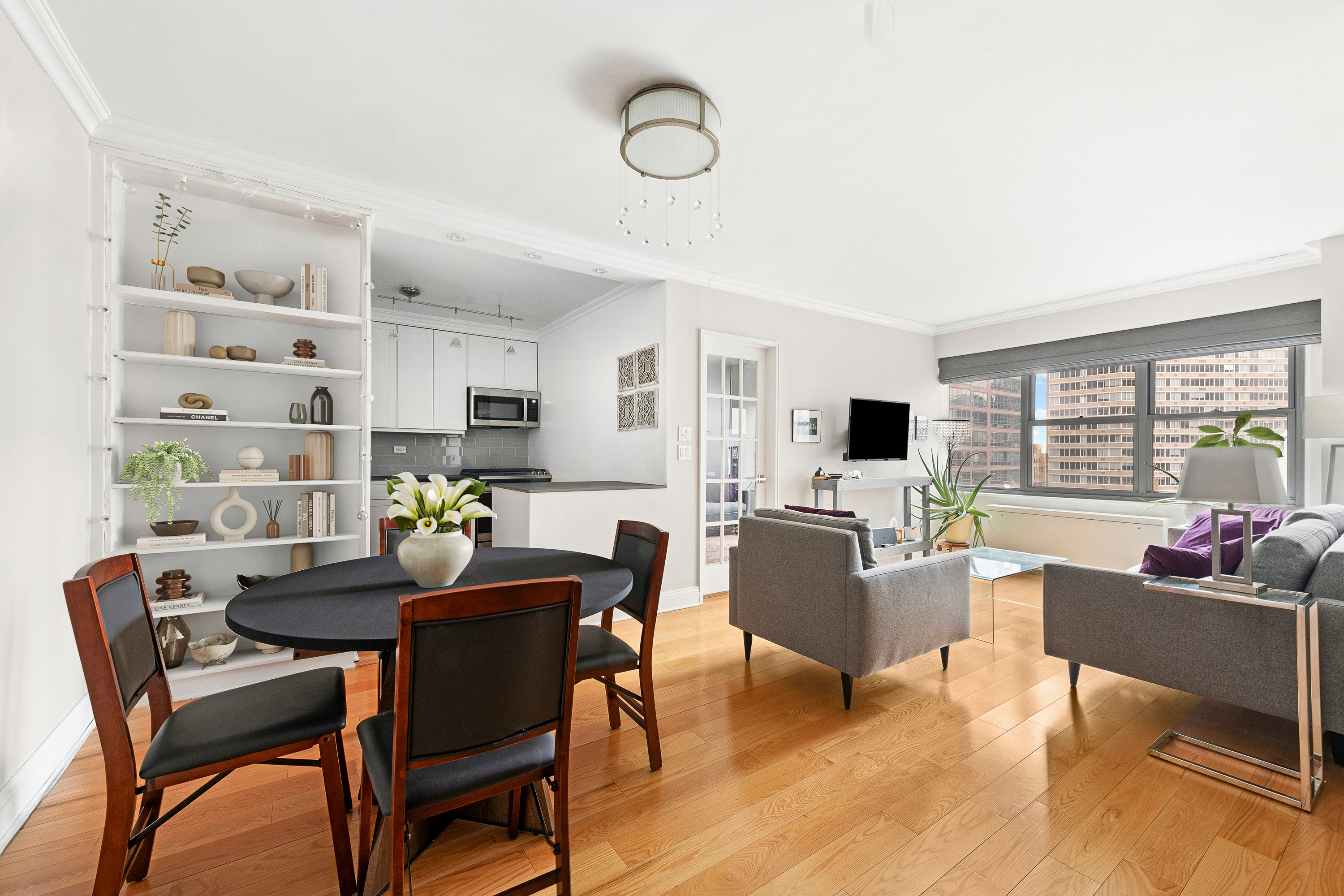 400 East 56th Street, Unit 19O Manhattan, NY 10022 - Photo 1 of 20 a view of a dining room with furniture window and outside view