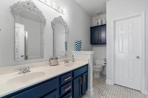 a bathroom with a double vanity sink and a mirror
