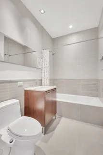 a bathroom with a toilet and a bathtub