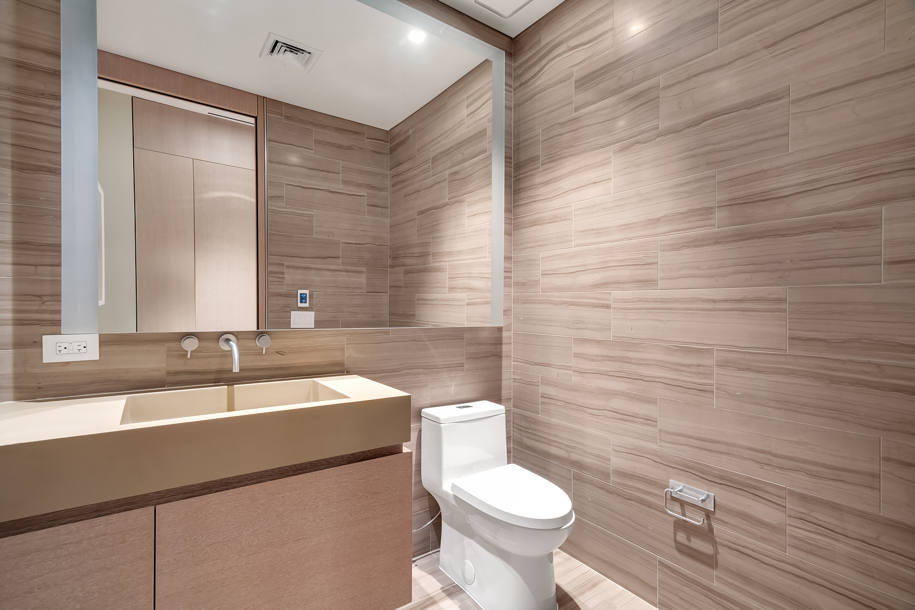 49 Chambers Street, Unit 11D Manhattan, NY 10007 - Photo 15 of 30 a bathroom with a sink a toilet and mirror